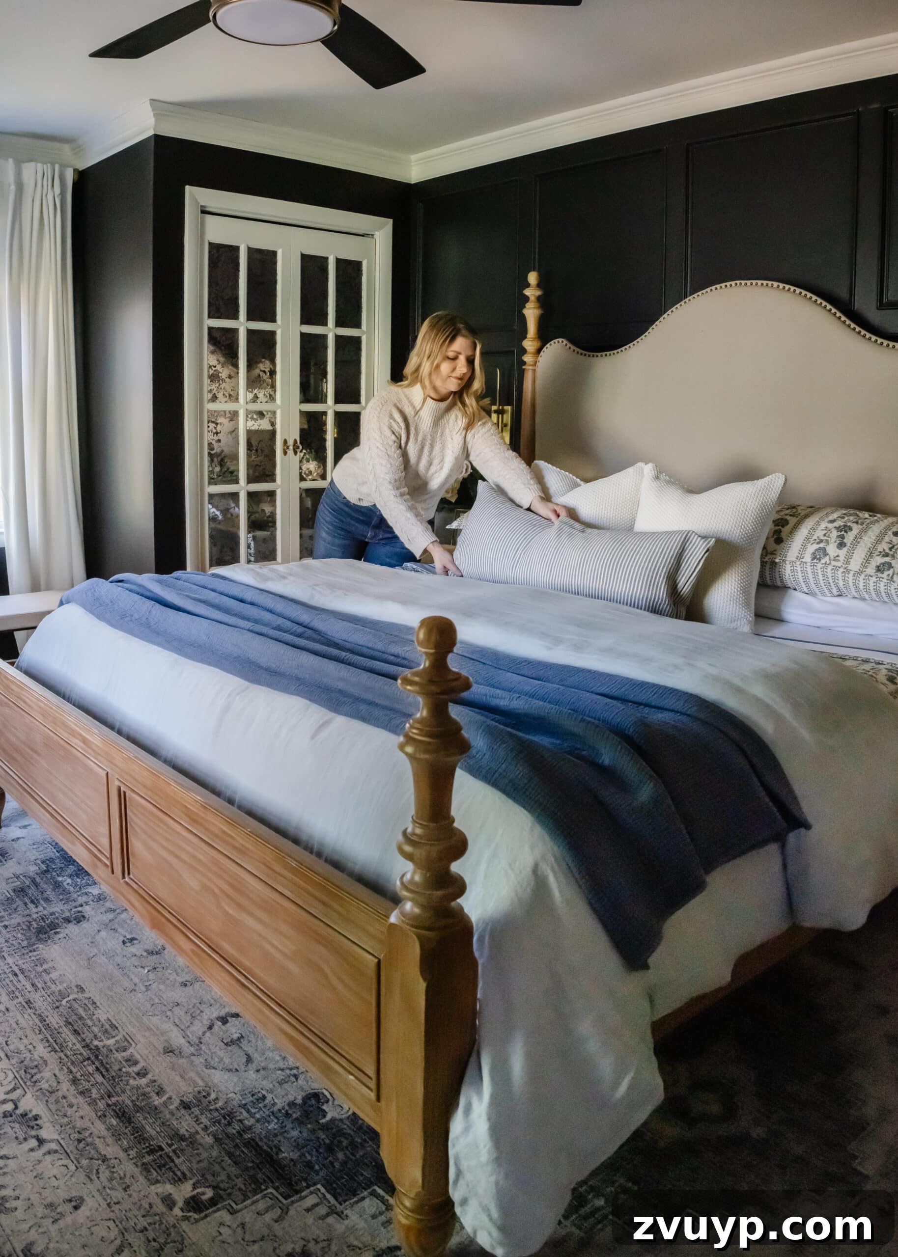 Master the Magazine Worthy Bed 15 A fully made bed with layers of luxurious bedding, decorative pillows, and a throw blanket, creating a cozy and inviting bedroom scene.