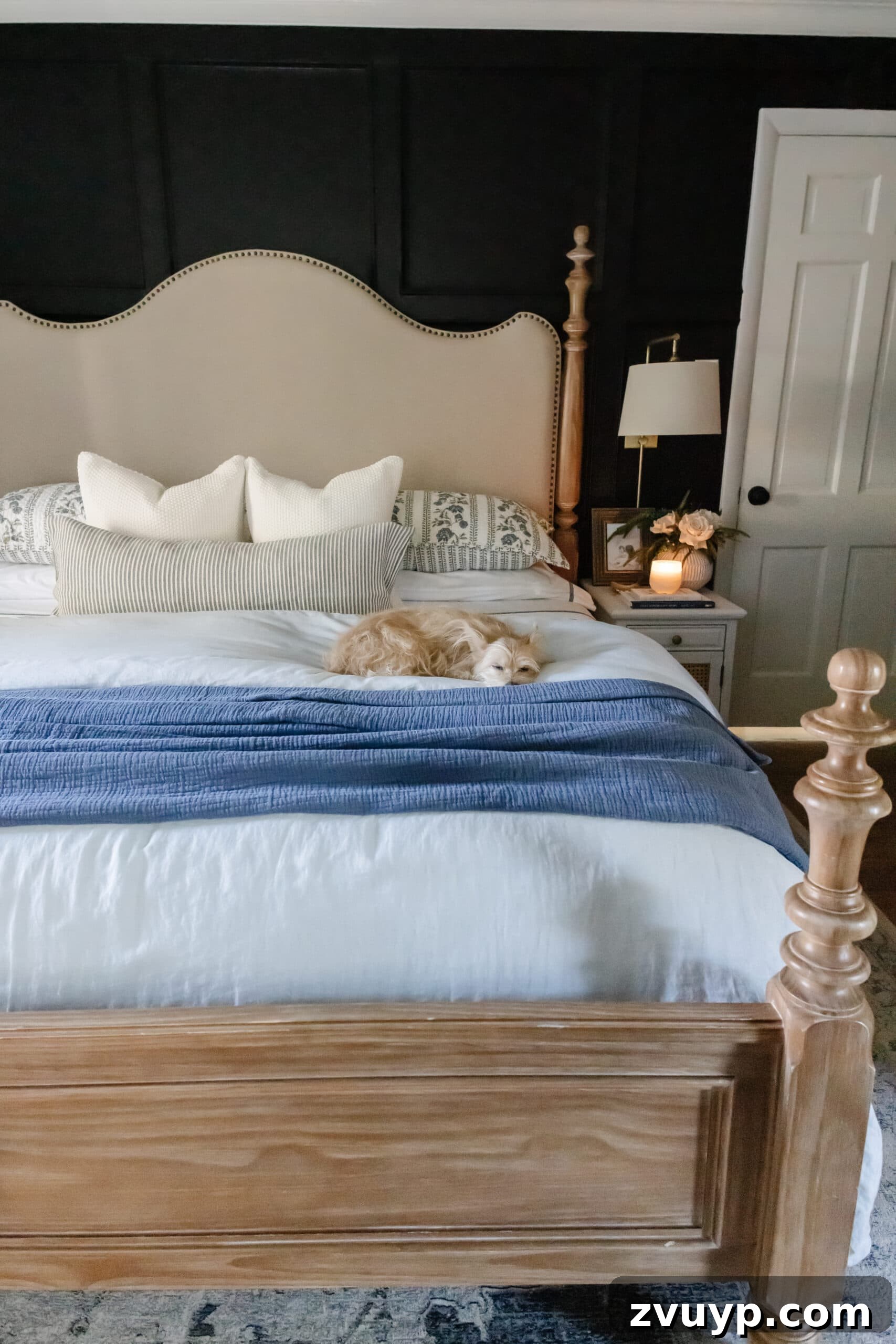 Master the Magazine Worthy Bed 3 Close-up of a neatly made bed with layers of white and patterned bedding, showcasing a perfectly tucked duvet and stacked pillows.