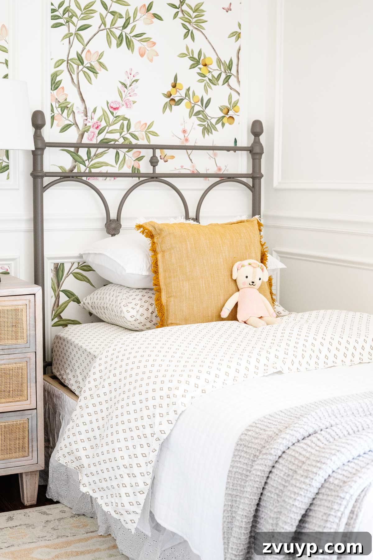 Master the Magazine Worthy Bed 8 A child's bed with printed sheets folded back to reveal the pattern, demonstrating the upside-down sheet placement technique.