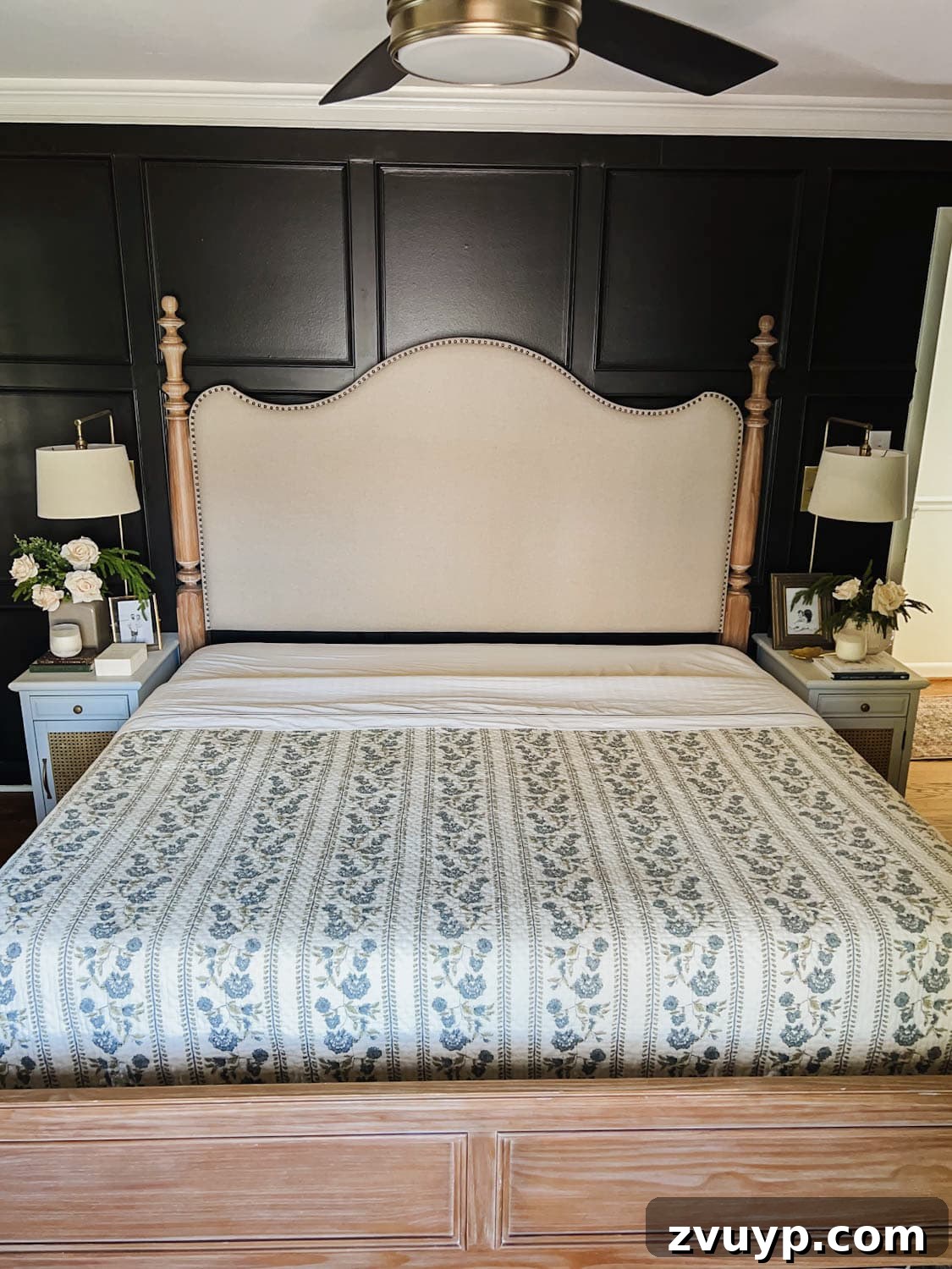 Master the Magazine Worthy Bed 9 A vintage floral pattern quilt layered over white sheets, illustrating the step of adding a coverlet or quilt to the bed.