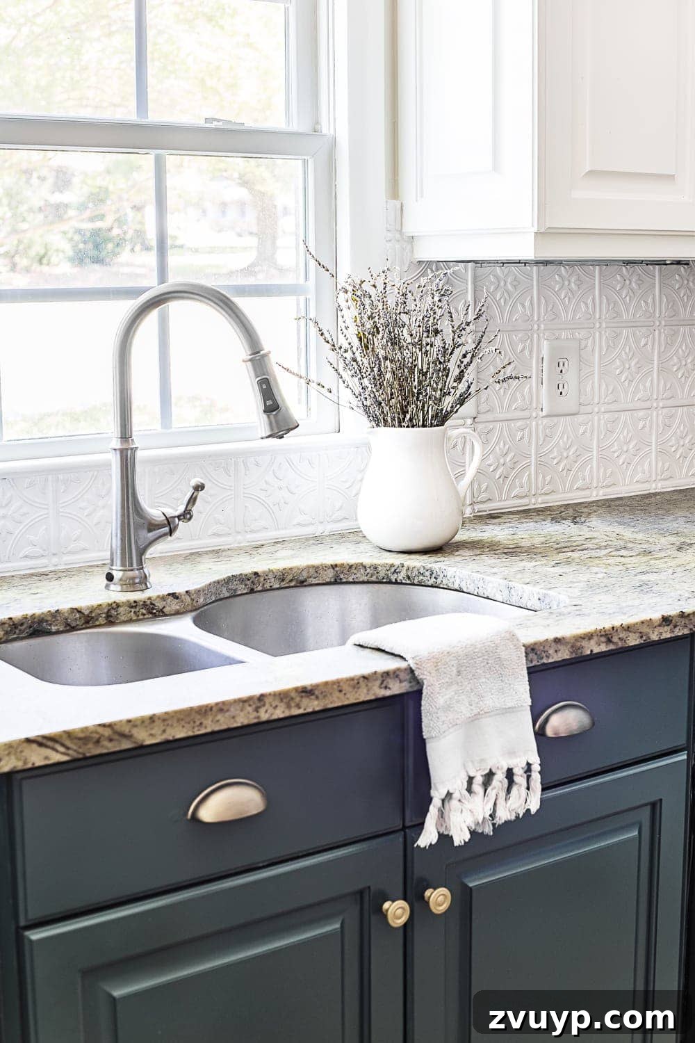Vibrant Green Kitchen Cabinet Makeover 6 Pressed tin ceiling tile backsplash complemented by deep green kitchen cabinets, creating visual texture