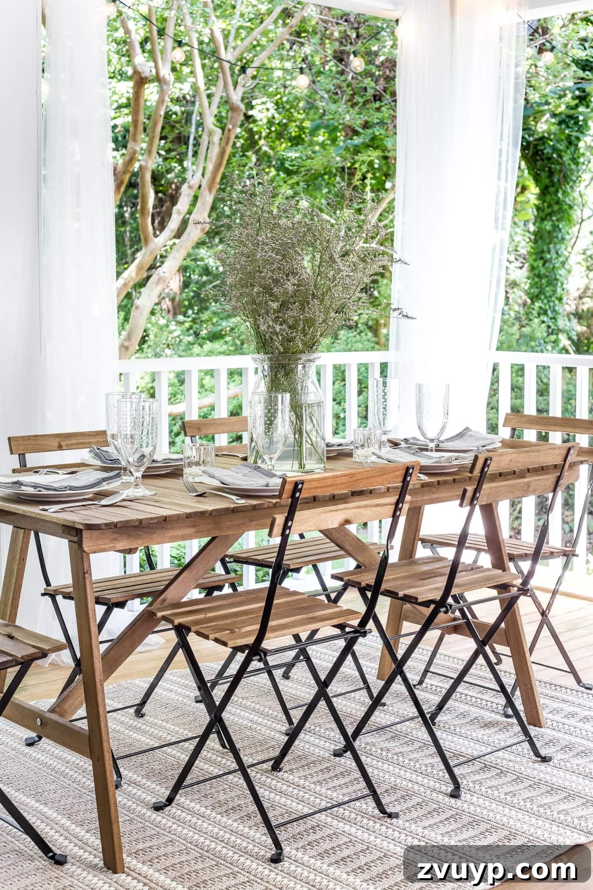 Our Summer Porch Haven 15 Back porch outdoor dining table with breezy sheer curtains and string lights