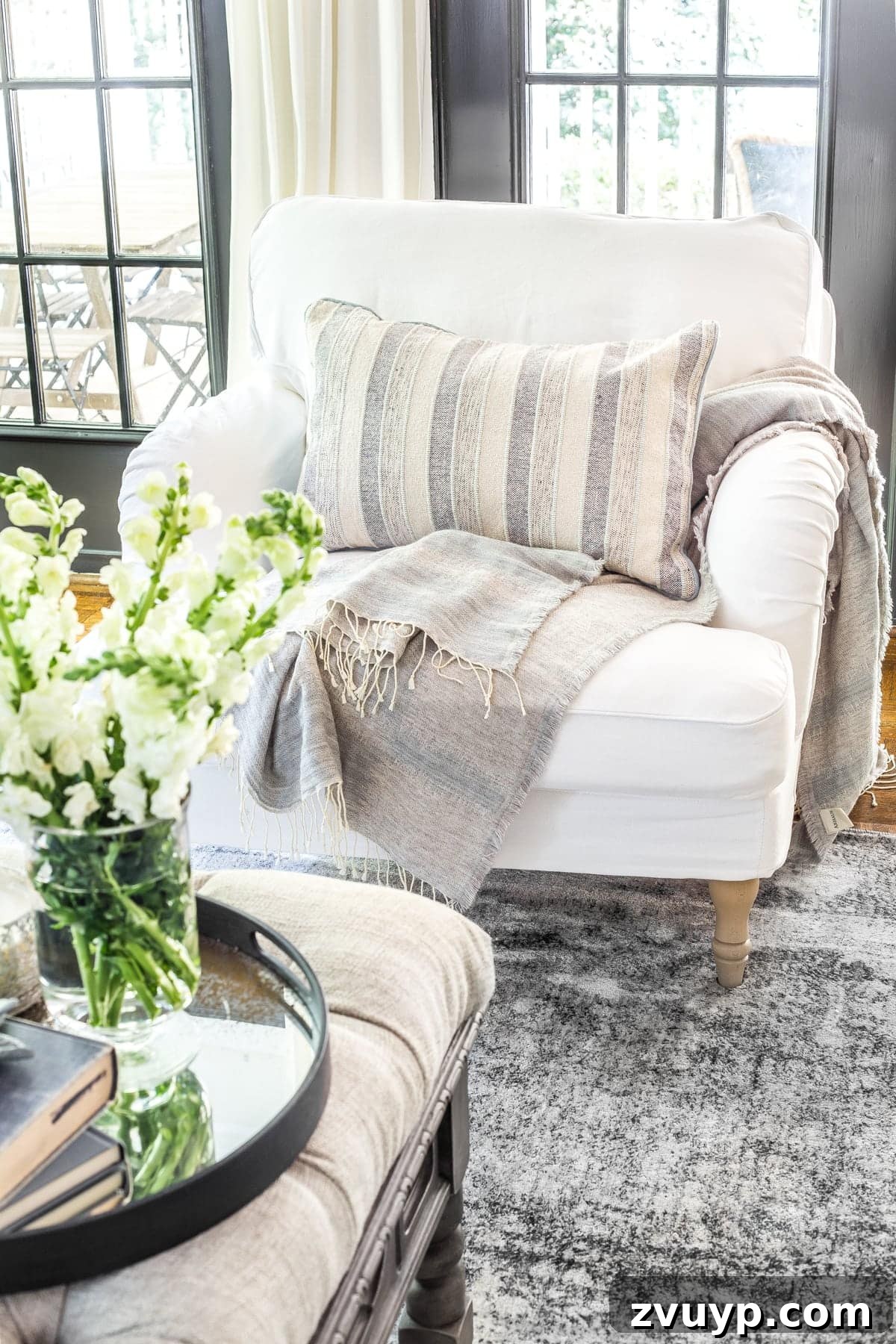 A comfortable living room armchair with exposed legs, strategically chosen to make a small room look more open and spacious.