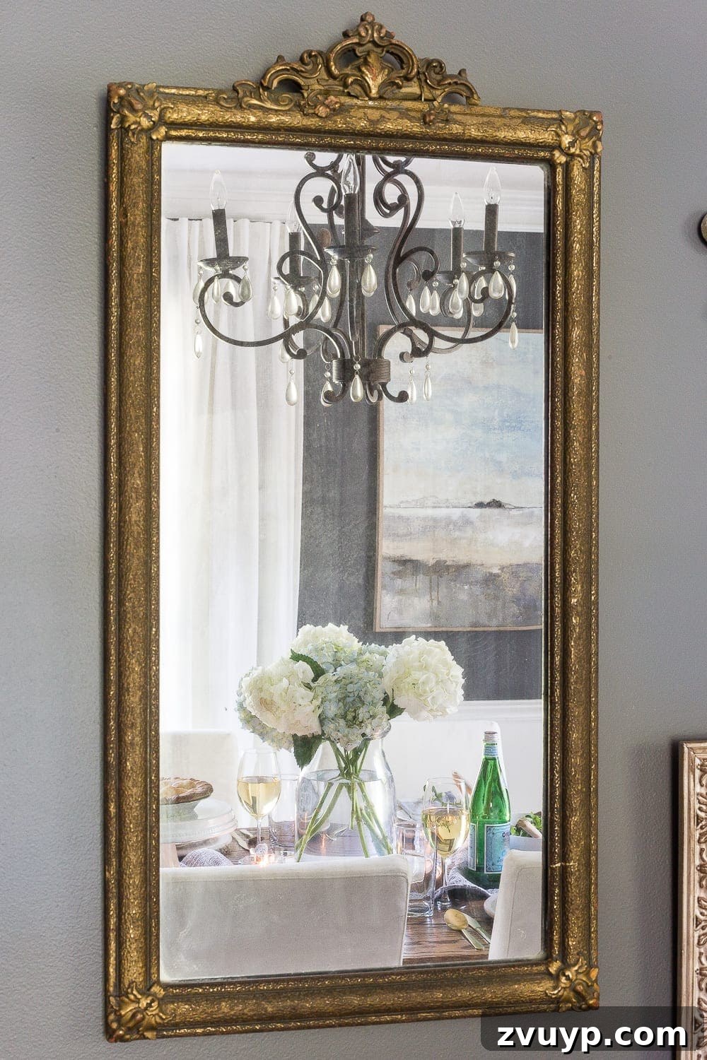 A strategically placed mirror in a dining room, reflecting the dining table and creating the illusion of more space and light.