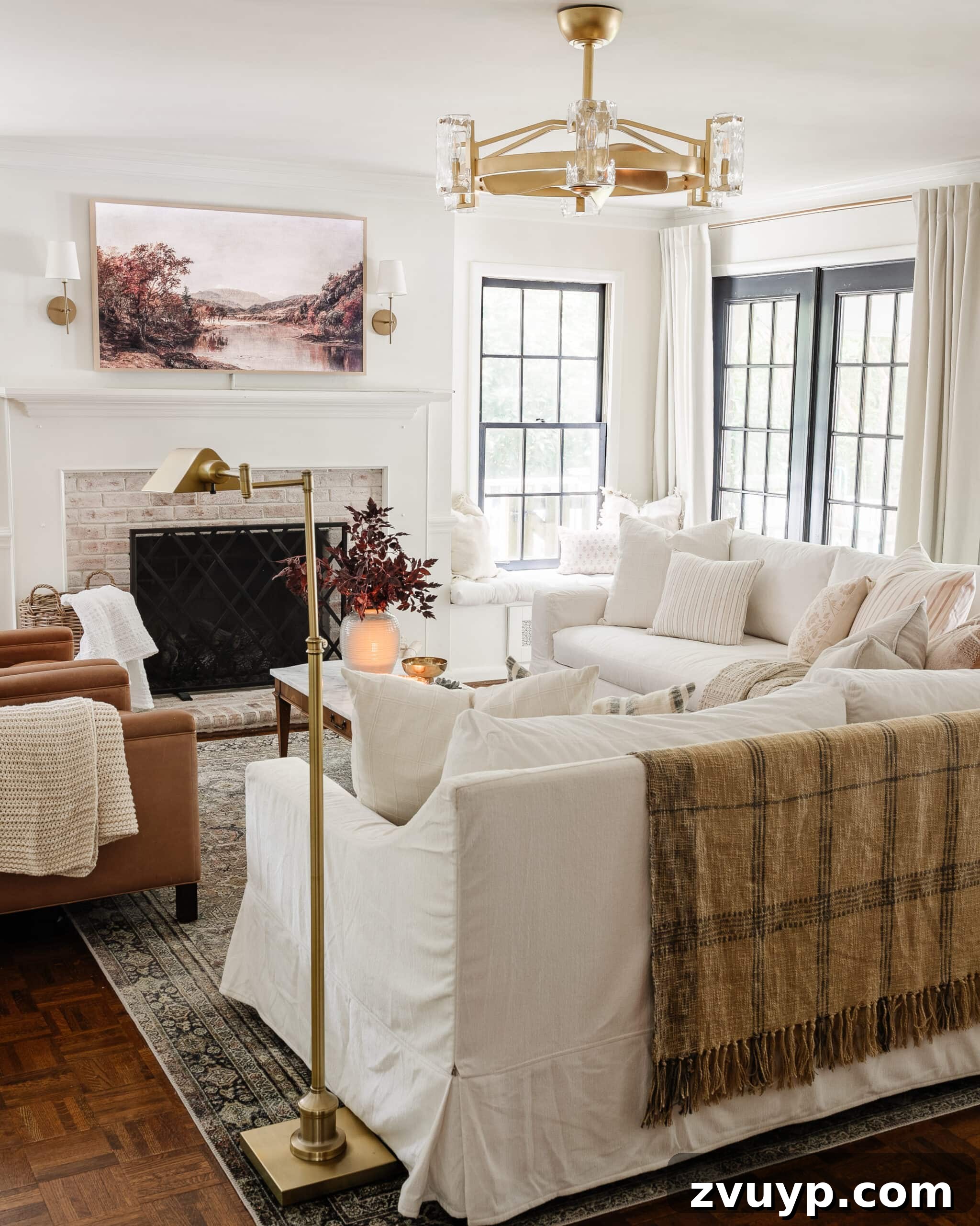 A monochromatic living room featuring white sofas, white walls, and white curtains, demonstrating how matching furniture to walls creates an open and unified aesthetic.