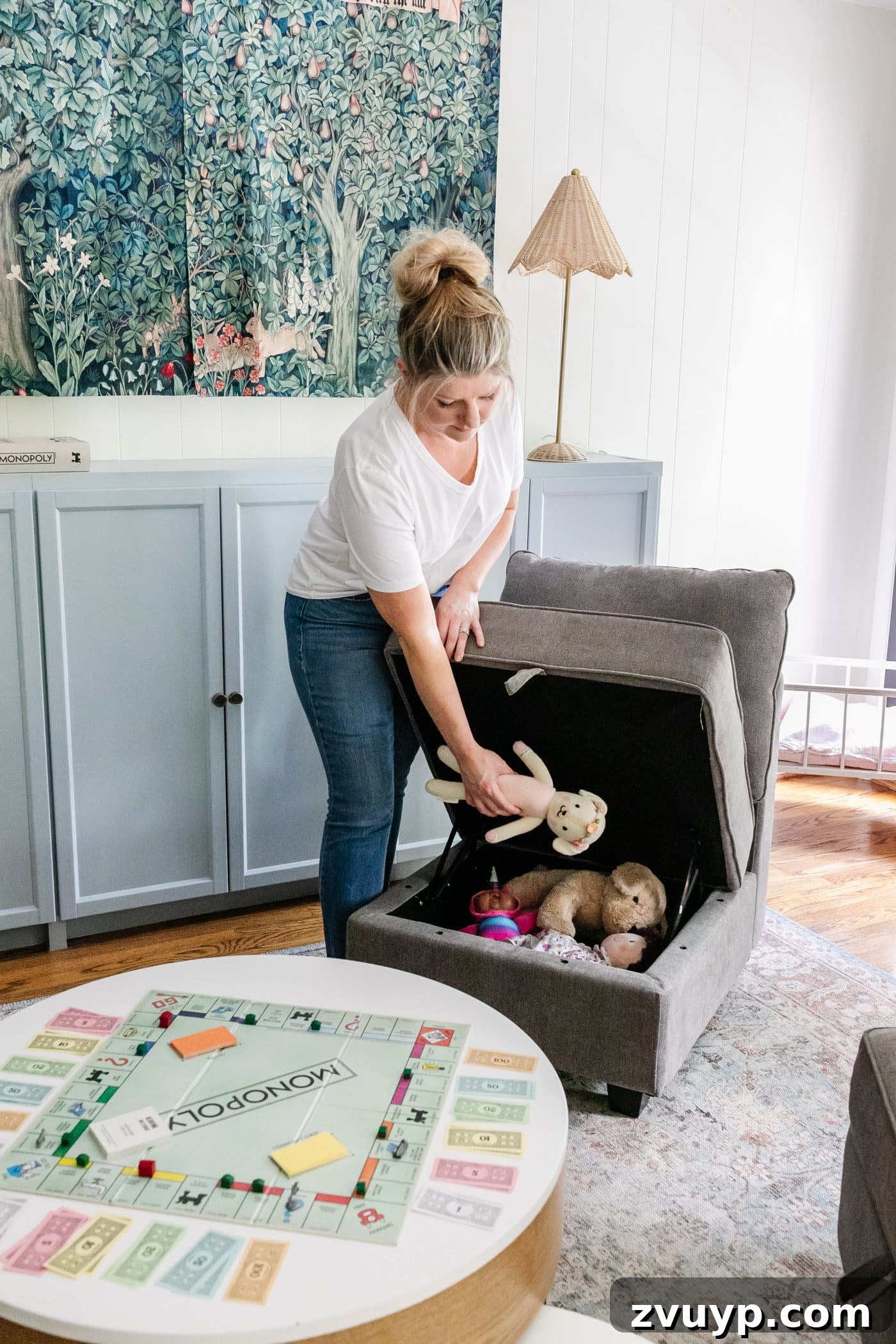 A vibrant playroom showcasing smart storage solutions with a toy storage chair, sky blue cabinets, and a storage coffee table filled with board games, perfect for maximizing a small room.