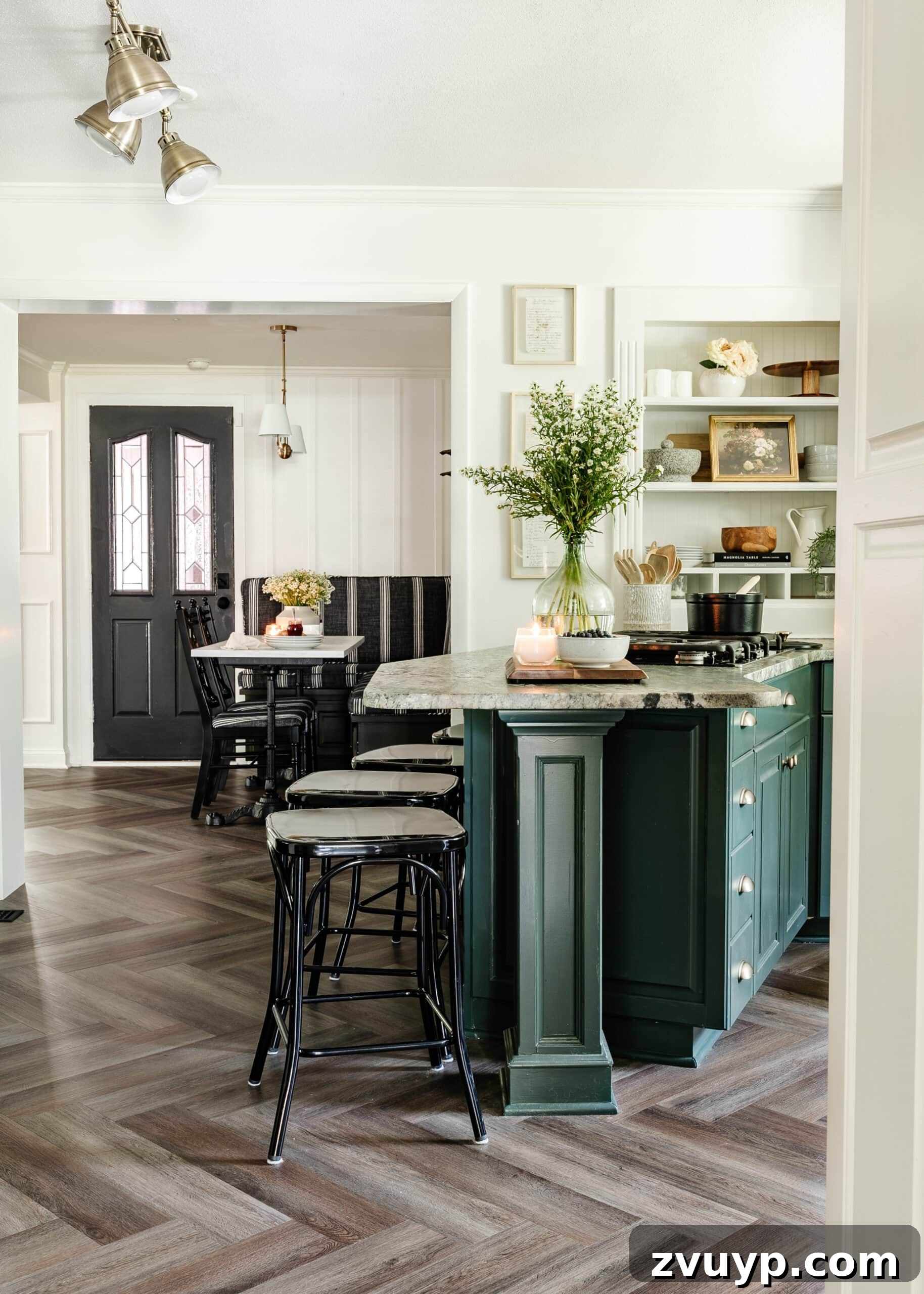Cozy Cottagecore Kitchen Transformations That Won't Break the Bank 11 View of the kitchen peninsula looking into the breakfast nook, showcasing the new lighting and design elements.