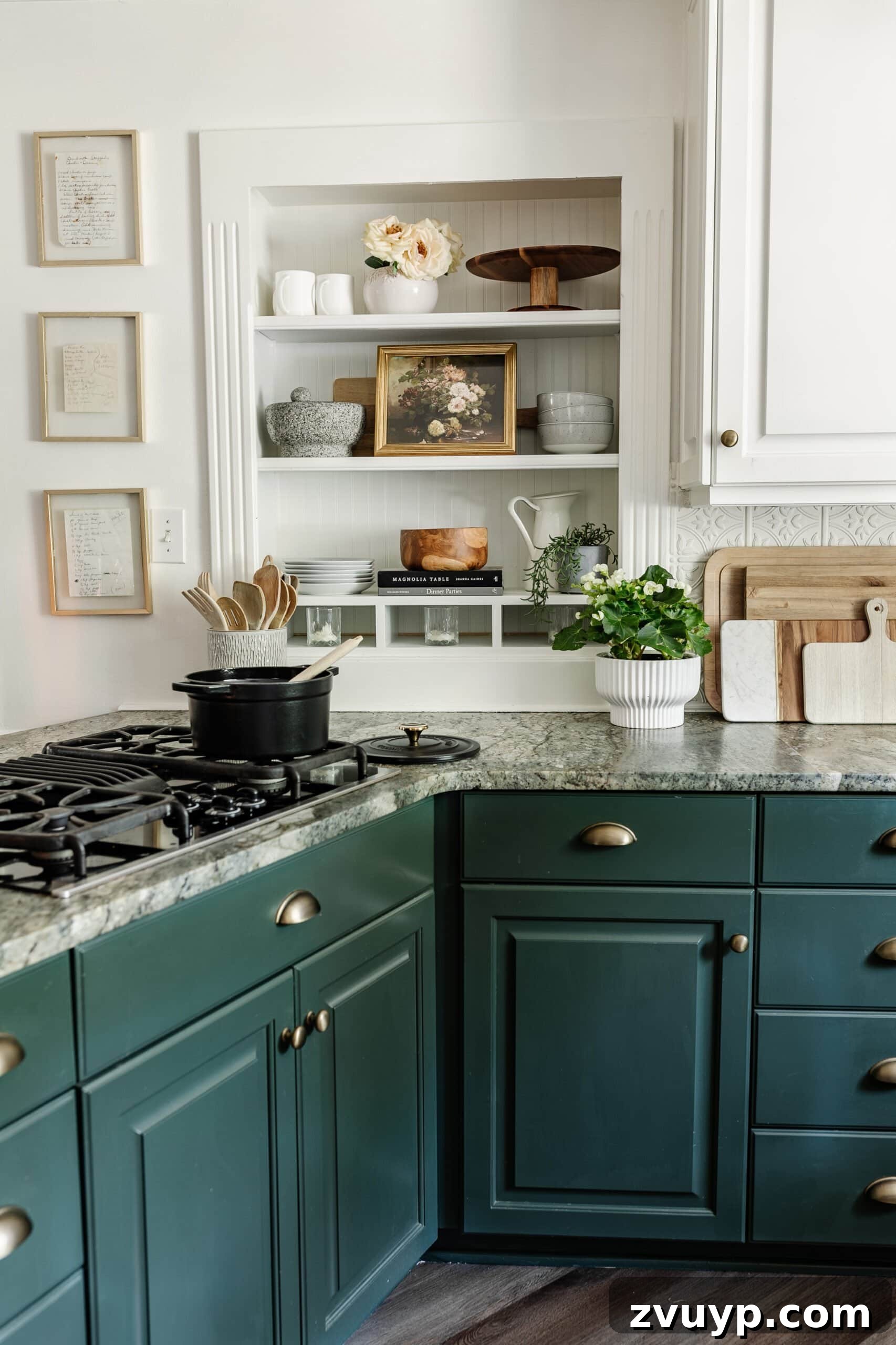 Cozy Cottagecore Kitchen Transformations That Won't Break the Bank 18 An open kitchen shelf beautifully styled with plates, bowls, and various serving ware, along with a piece of art, showcasing a neat and functional display.