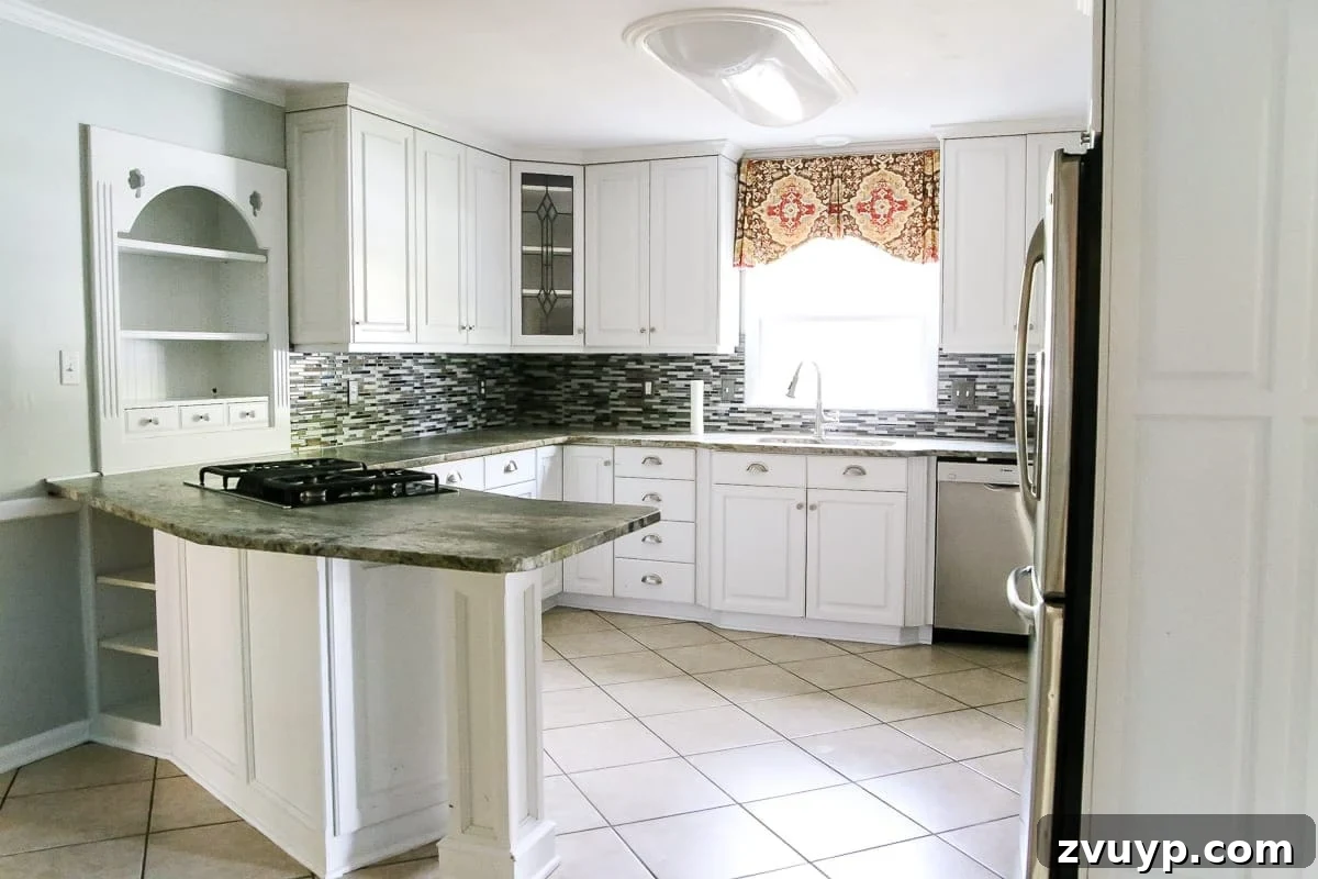 Cozy Cottagecore Kitchen Transformations That Won't Break the Bank 4 The original kitchen before the refresh, showing its dated appearance with older cabinetry and flooring.