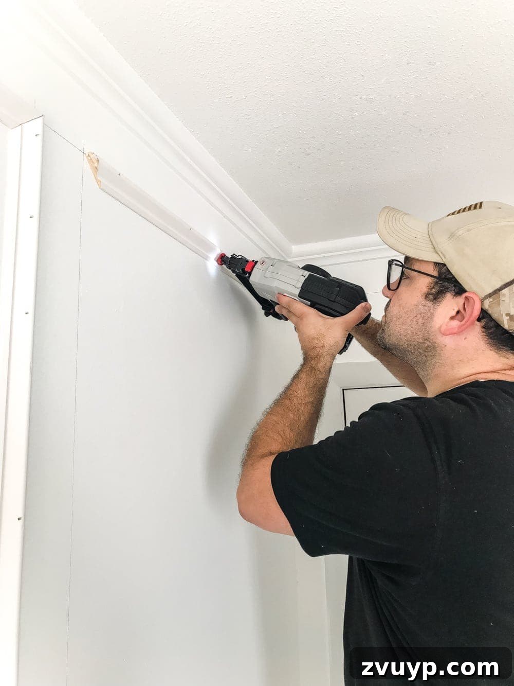 Crafting Your Perfect Picture Frames 11 Brad nailer in action securing picture frame molding to the wall