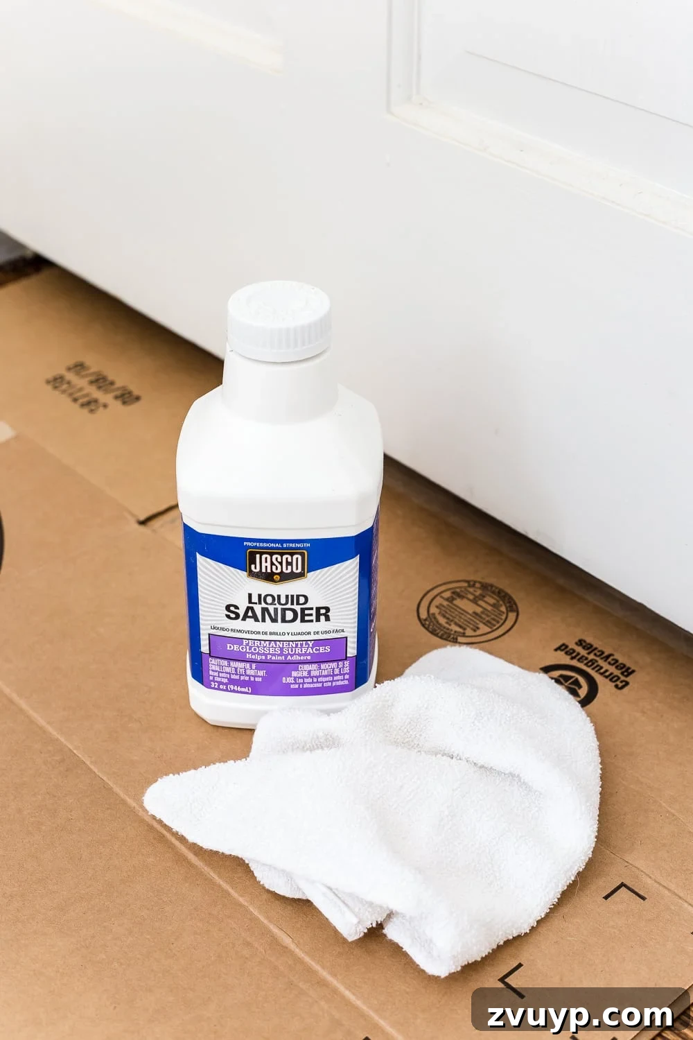 Mastering Door Painting for Unrivaled Durability 12 applying liquid deglosser to interior door before painting