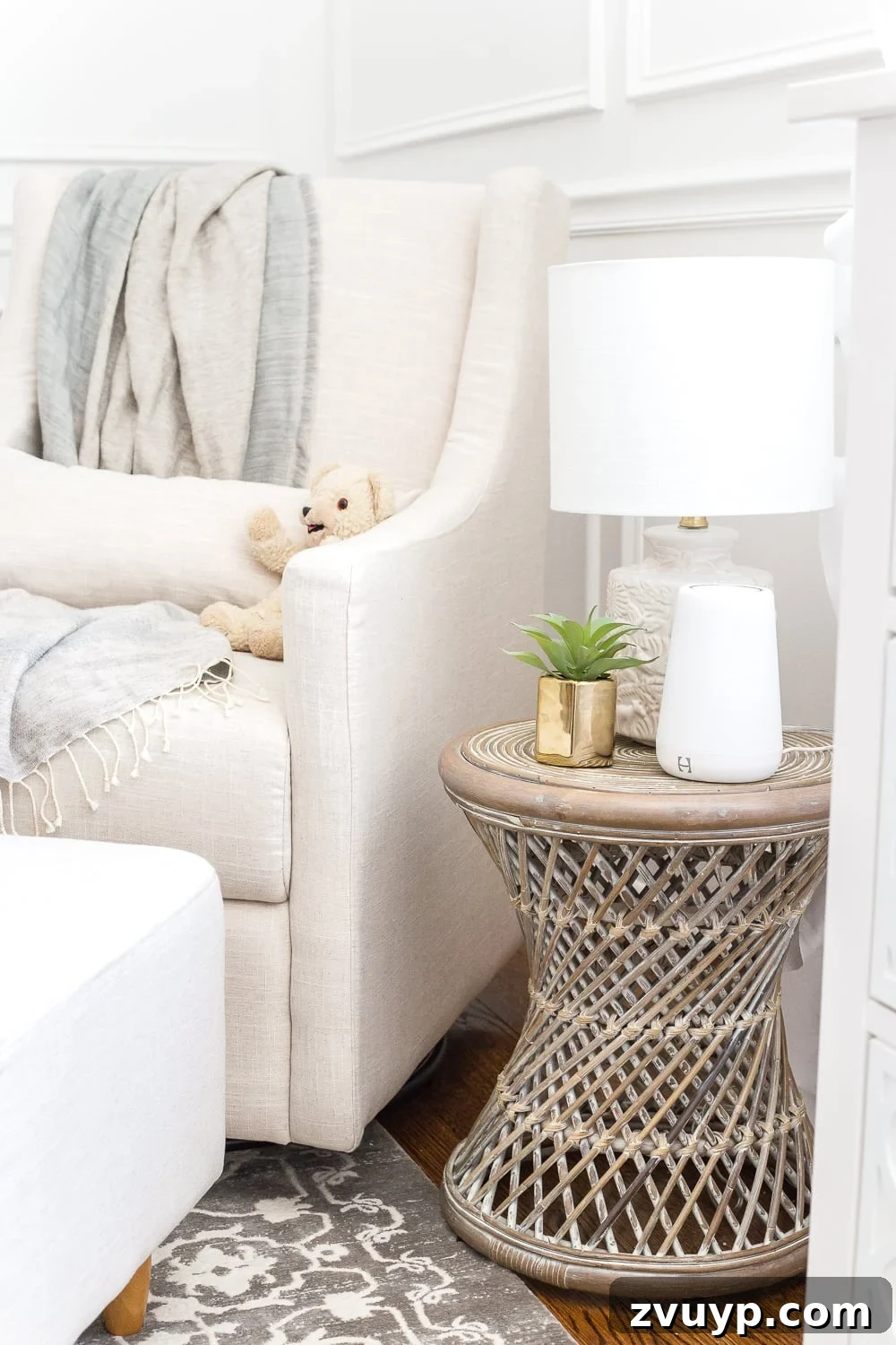 Inside Our Perfectly Organized Nursery 24 Nursery organization | Keep a side table beside a glider with a lamp featuring a sleeper bulb to promote sleep and a sound machine for soothing baby
