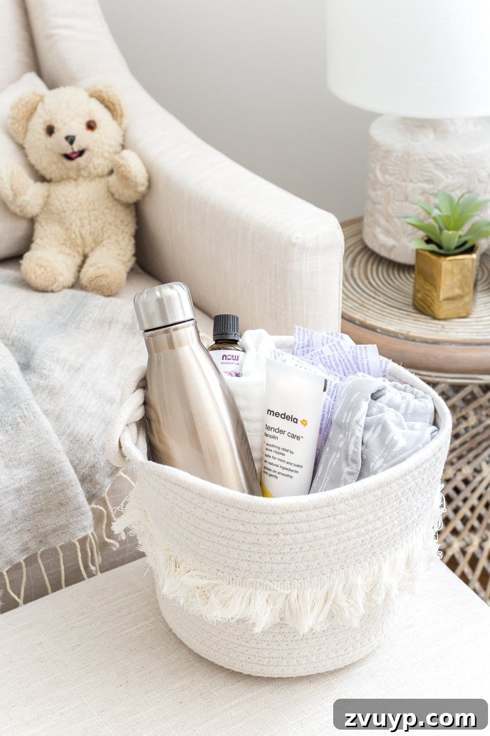 Inside Our Perfectly Organized Nursery 25 Nursery Organization | Breastfeeding basket to keep beside a chair, filled with nursing pads, water bottle, lanolin, burp cloths, nursing cover, and lavender essential oil for a relaxing environment