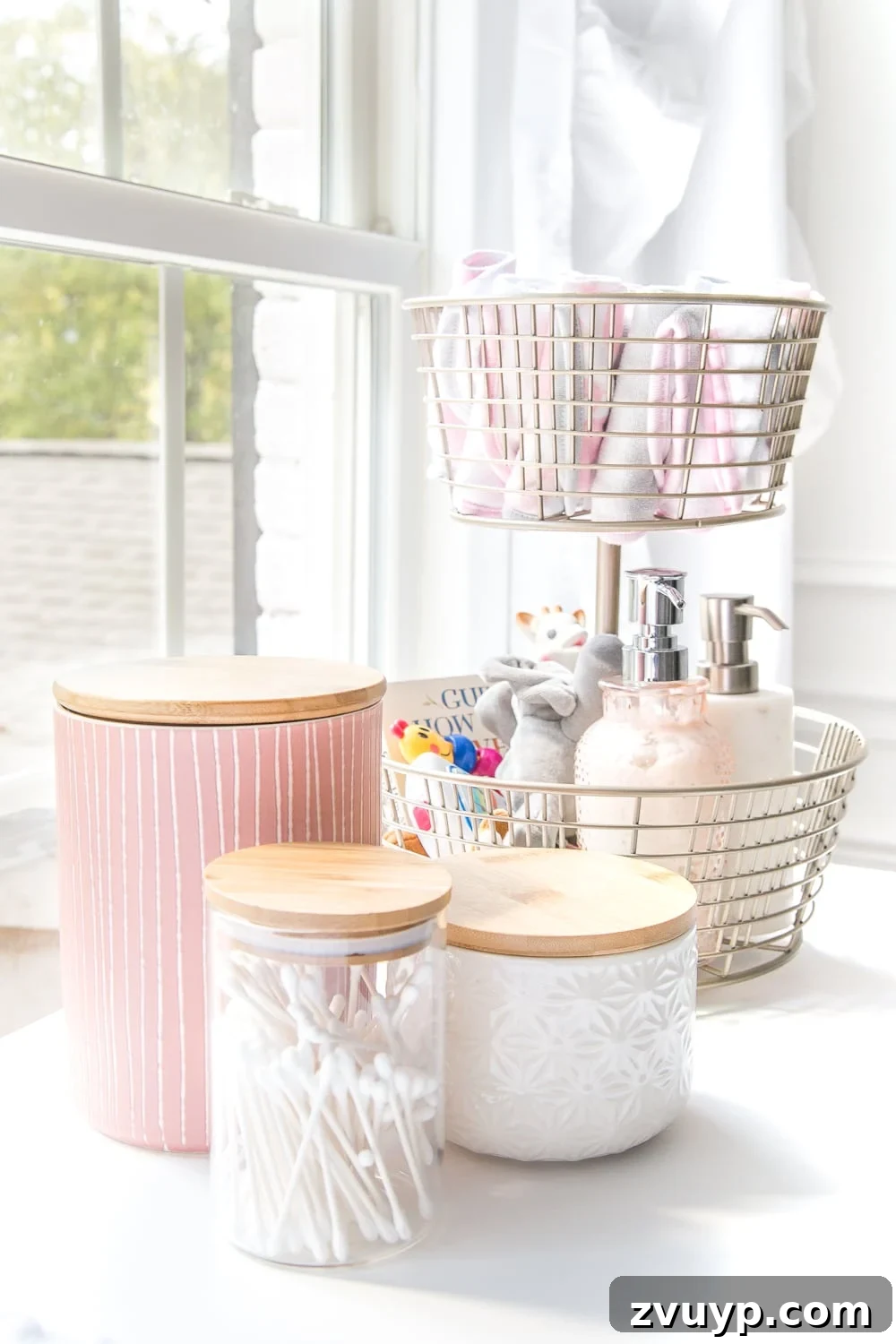 Inside Our Perfectly Organized Nursery 4 Nursery Organization | Use a tiered fruit basket from the kitchenware aisle to store baby washcloths, small toys, Wubbanubs, lotion, and hand sanitizer. Lidded kitchen canisters for Q-tips, pacifiers, and hair bows are also useful.