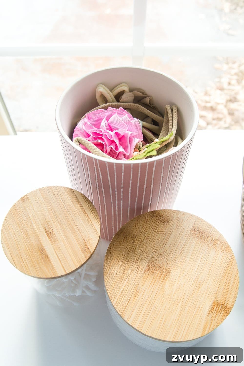 Inside Our Perfectly Organized Nursery 5 Nursery Organization | Use lidded canisters from the kitchenware aisle to store baby headbands and bows neatly