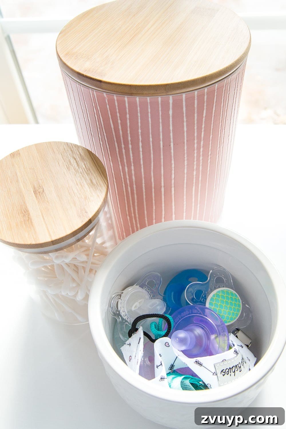 Inside Our Perfectly Organized Nursery 6 Nursery Organization | Use lidded canisters from the kitchenware aisle to store pacifiers for hygiene