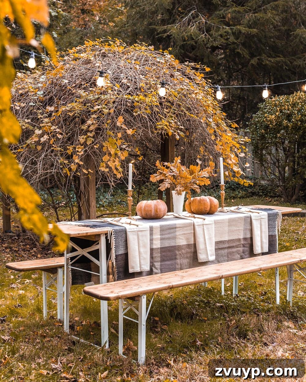 Outdoor scene showing the beer garden table with Thanksgiving decor and string lights draped above