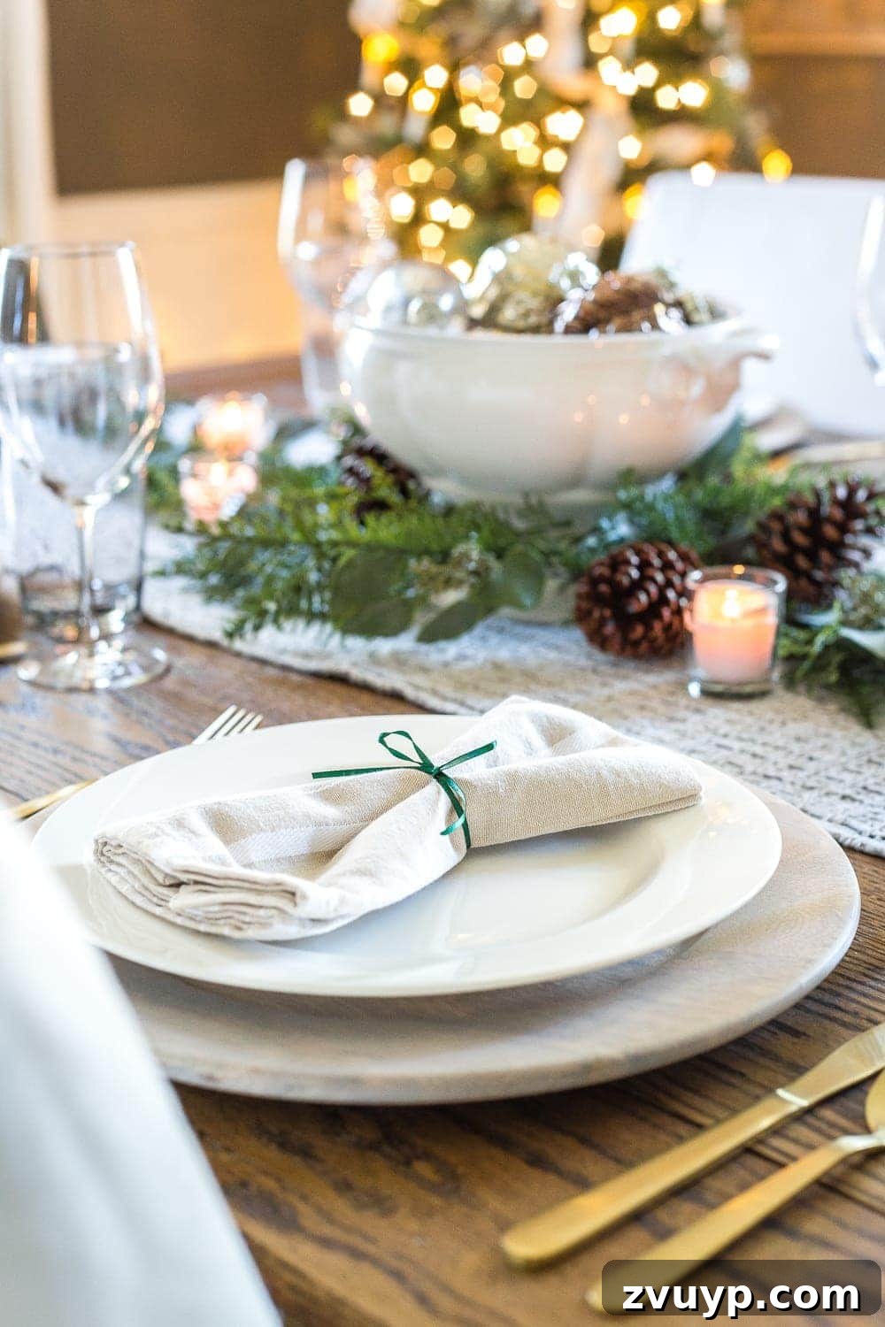 Festive Home Tours 2018 13 Table setting featuring festive green ribbon napkin holders and elegant dinnerware.