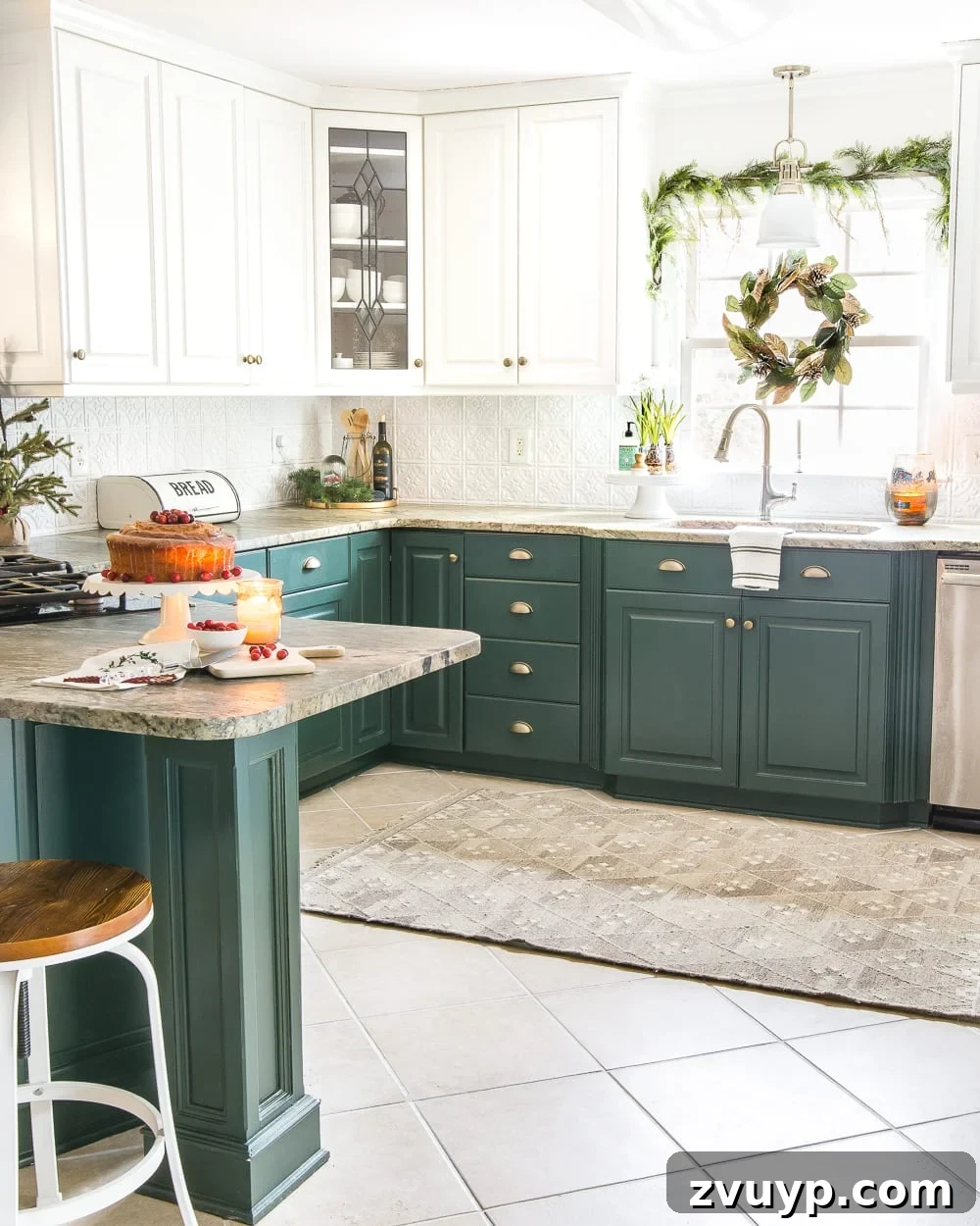 Festive Home Tours 2018 16 Our refreshed kitchen decorated for Christmas, featuring dark green lower cabinets, festive garland, and elegant white upper shelves.