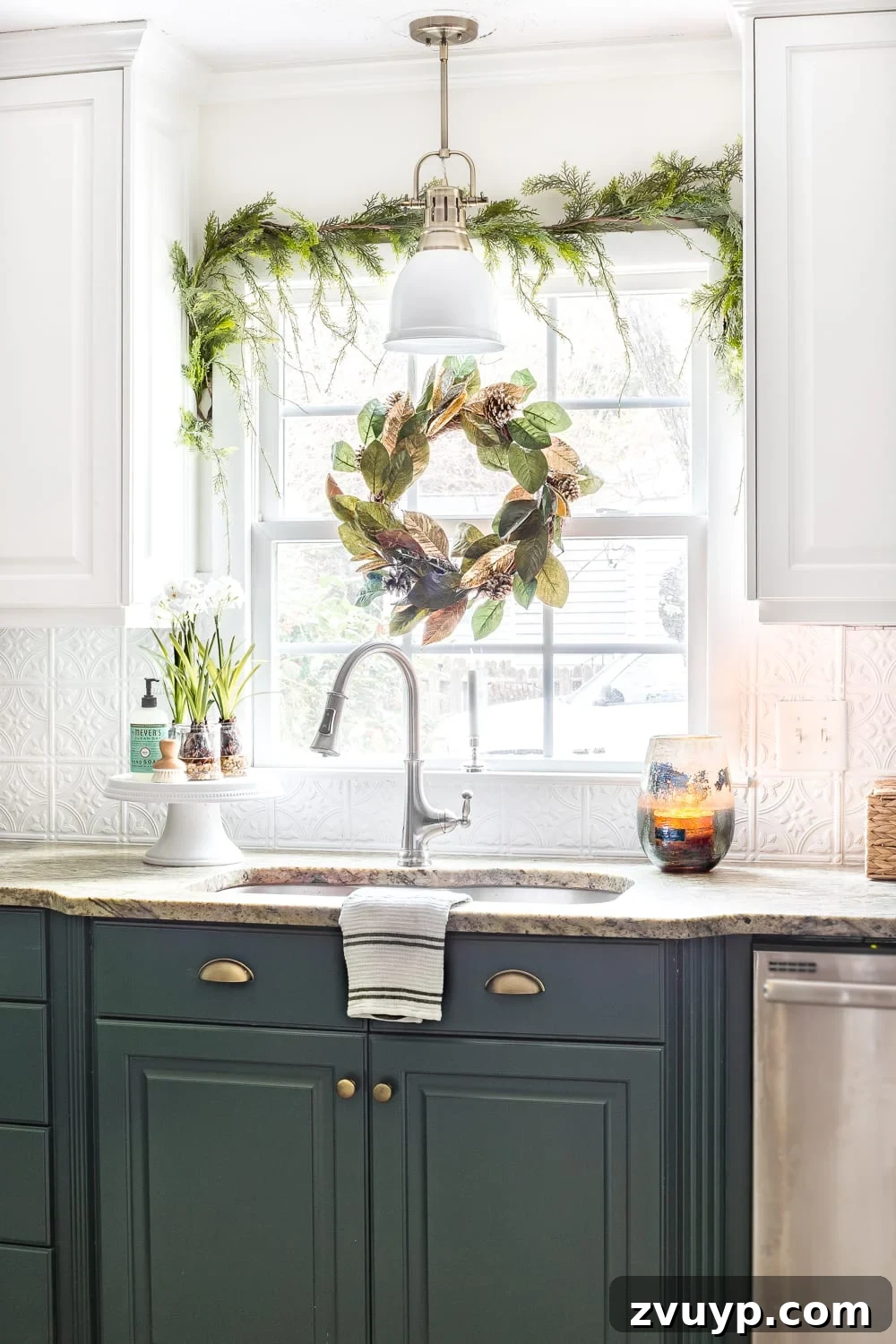 Festive Home Tours 2018 17 Kitchen sink area with a realistic artificial pine garland over the window, a magnolia wreath, and artificial paperwhites, enhancing the Christmas mood.