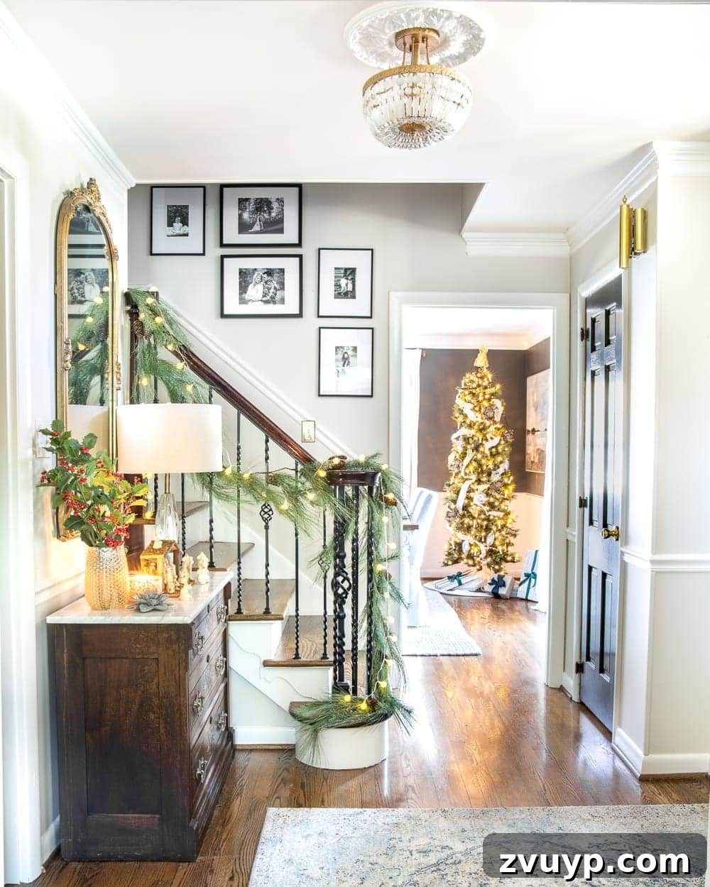 Festive Home Tours 2018 3 A view of the main staircase in the foyer, decorated with a simple Christmas garland and a vase of holly, reflecting easy holiday charm.