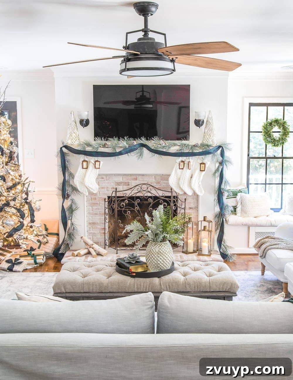 Festive Home Tours 2018 24 Our inviting living room decorated for Christmas, featuring a large couch, a festive tree, and cozy holiday accents.