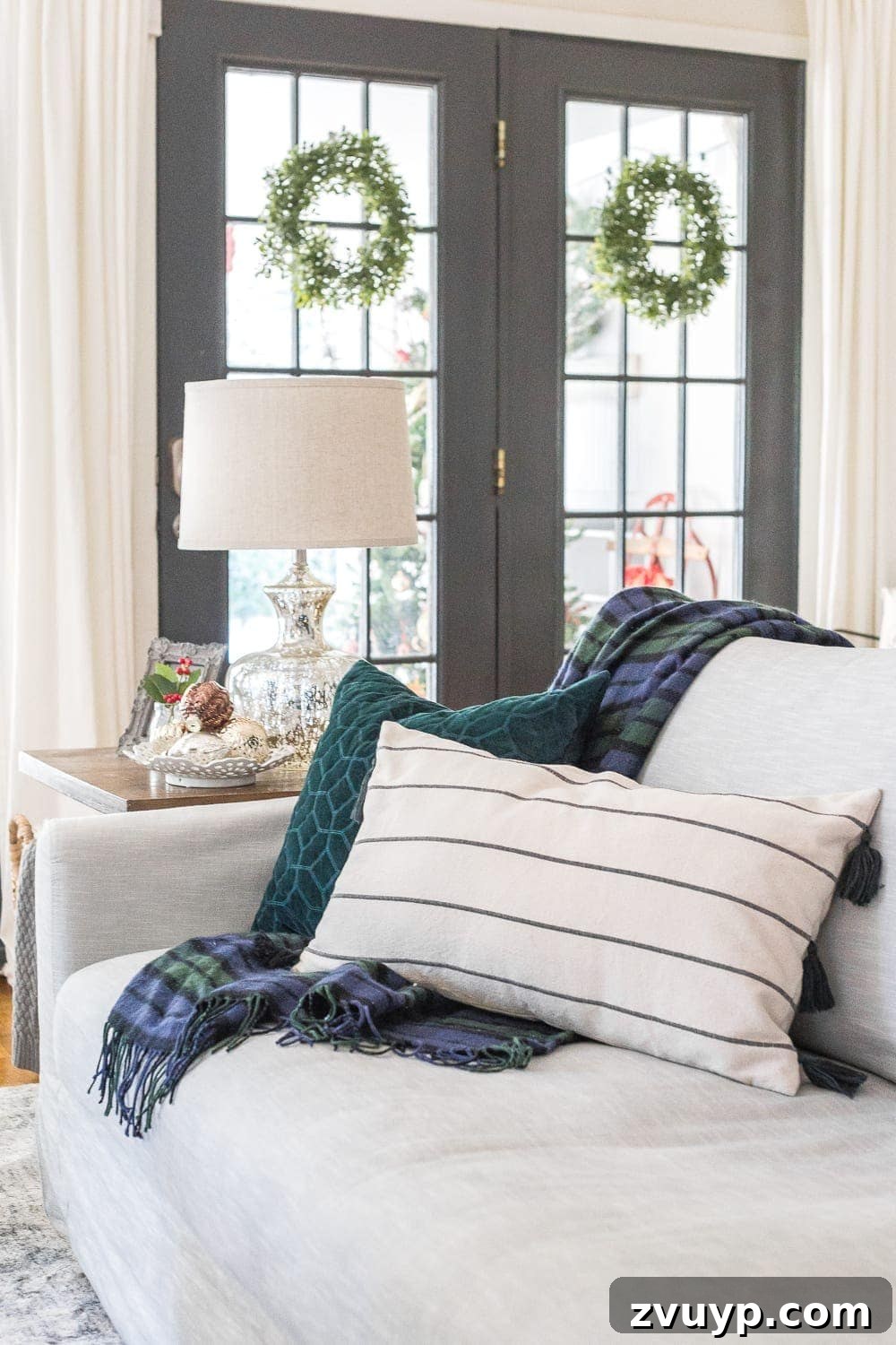 Festive Home Tours 2018 37 Close-up of comfortable sofa pillows in versatile green and blue tones, styled for the holiday season.
