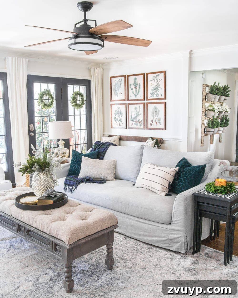 Festive Home Tours 2018 38 A final wide shot of the living room showcasing the complete Christmas decoration, including the tree, mantel, and cozy seating.