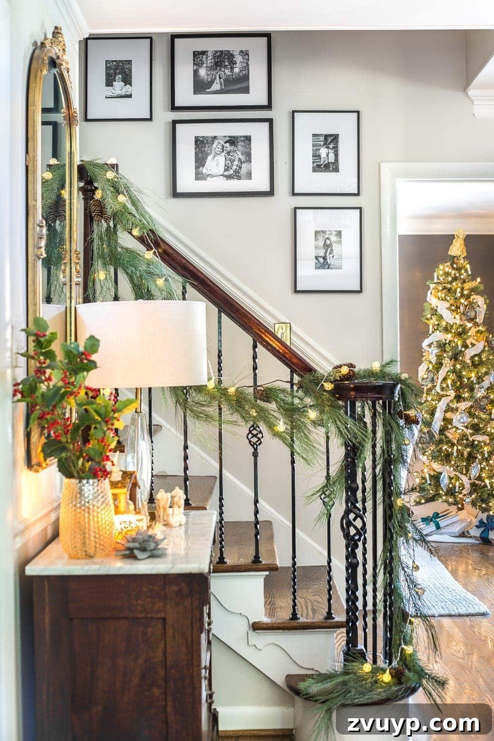 Festive Home Tours 2018 6 Another perspective of the foyer, highlighting the Christmas decorations and framed photographs, creating a welcoming and personal atmosphere.