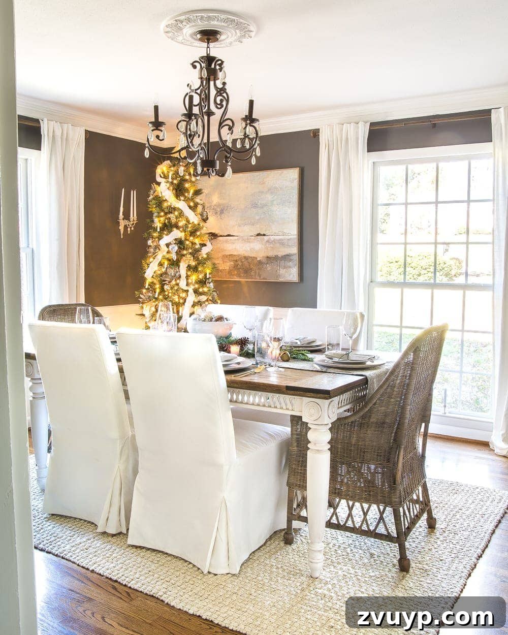 Festive Home Tours 2018 7 Our dining room, featuring a large wooden dining table, decorated with a Christmas centerpiece and a stunning mirror gallery wall.