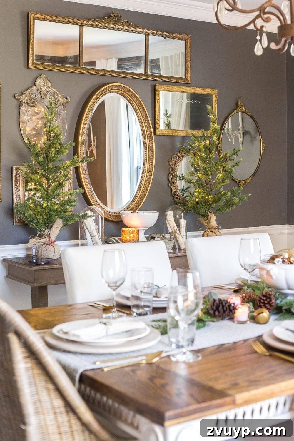 Festive Home Tours 2018 9 A wide shot of the dining room during Christmas, featuring the decorated table, mirror wall, and a glowing Christmas tree in the corner.