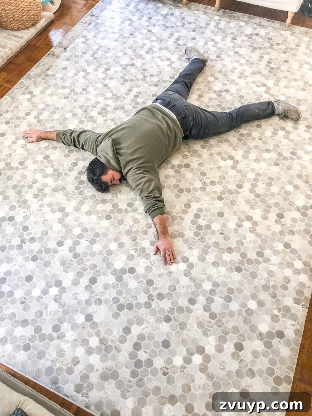 DIY Floor Makeover Seamless Sheet Vinyl Over Tile 13 A roll of sheet vinyl flooring unrolled partially on a floor, ready for marking and cutting.