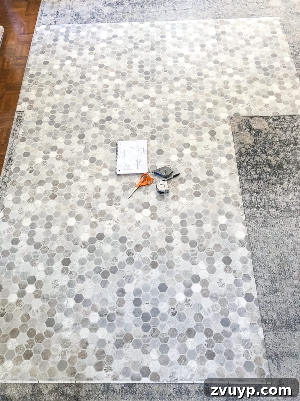 DIY Floor Makeover Seamless Sheet Vinyl Over Tile 16 The newly cut sheet vinyl template laid out on the floor, perfectly matching the room's dimensions and obstacles.