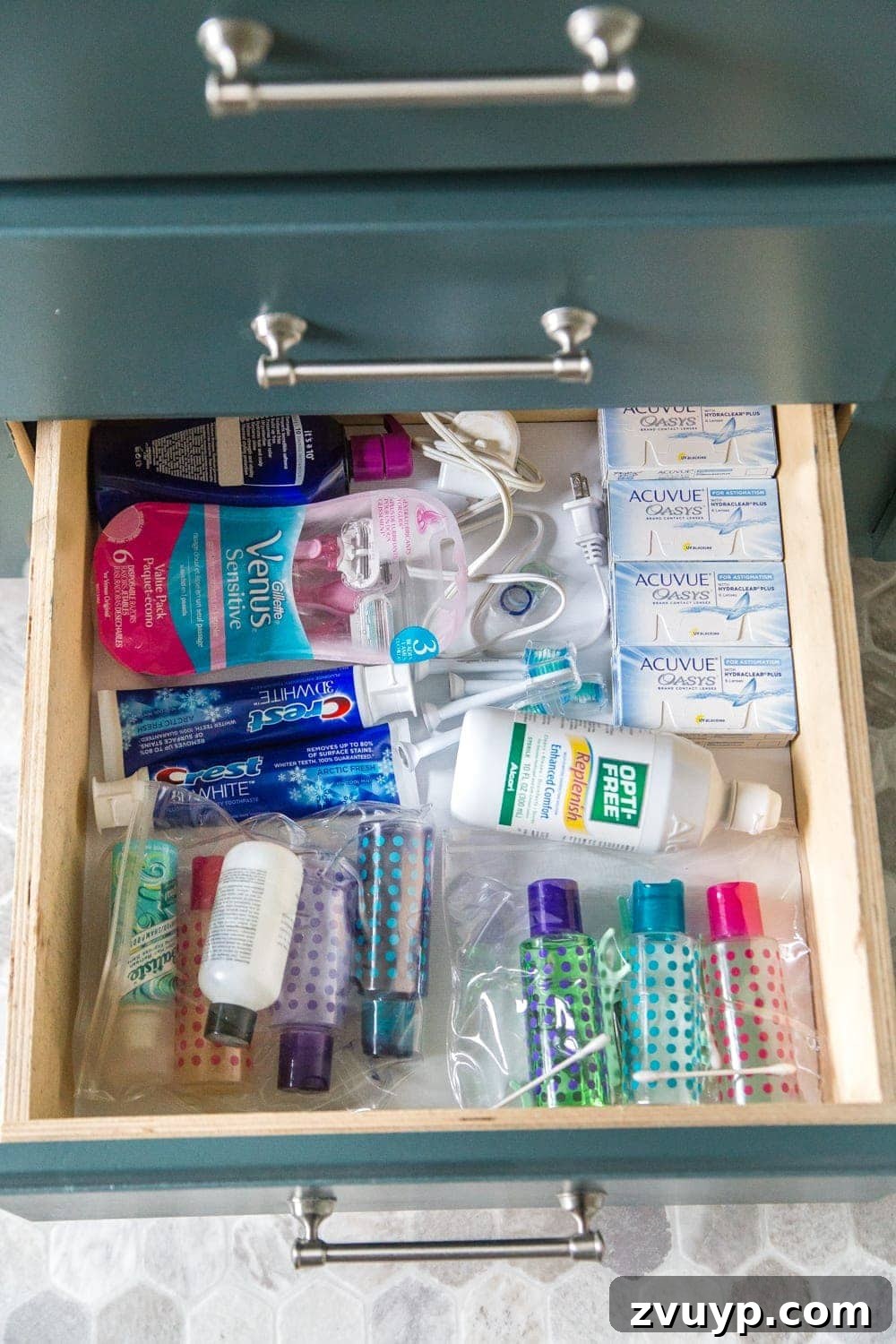 From Mess to Marvel: 6 Steps to a Perfect Bathroom Vanity 14 Travel Toiletries and Extra Supplies Drawer Organization - The bottom drawer housing spare toiletries and pre-packed travel bags.