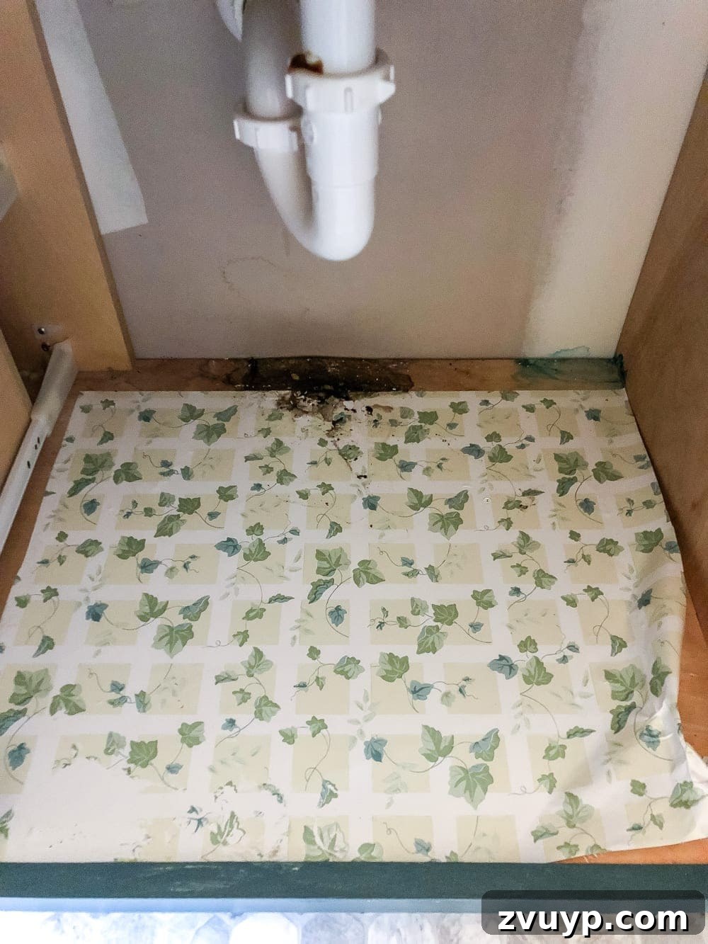 From Mess to Marvel: 6 Steps to a Perfect Bathroom Vanity 6 Applying White Wood Grain Contact Paper to Bathroom Drawer - A hand smoothing out fresh contact paper in an empty bathroom drawer.