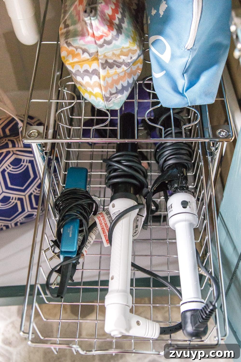 From Mess to Marvel: 6 Steps to a Perfect Bathroom Vanity 9 Close-up of Organized Hair Tool Drawer - Detailed view of a bathroom drawer with hair styling tools and accessories neatly arranged in compartments.