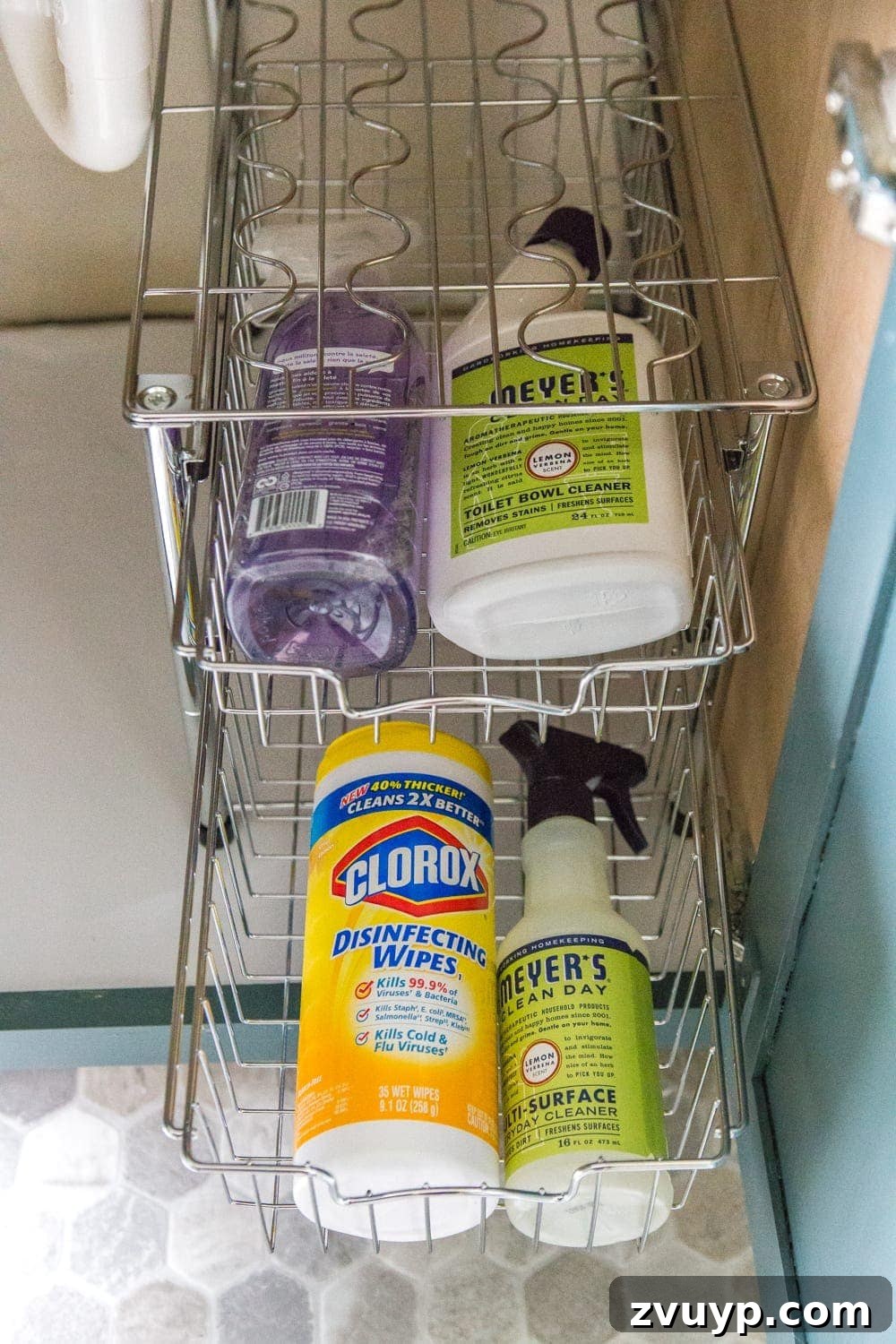 From Mess to Marvel: 6 Steps to a Perfect Bathroom Vanity 10 Organized Bathroom Cabinet with Cleaning Supplies - Robert's side of the vanity, showing cleaning products neatly stored in stackable baskets.