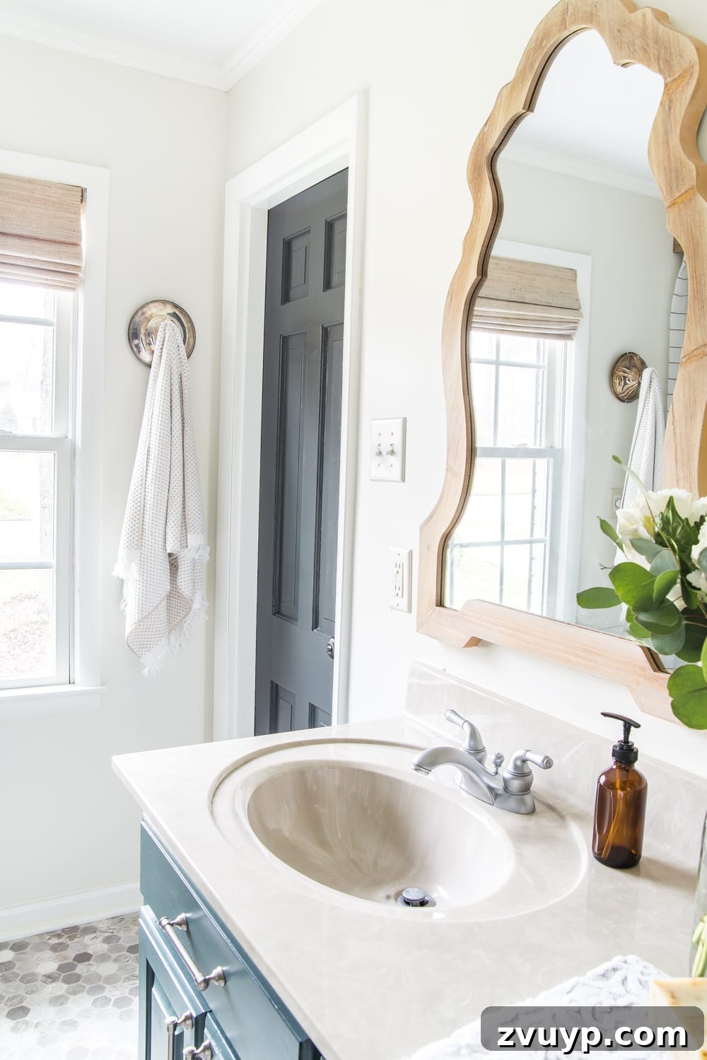 Budget Master Bath Glow-Up Unveiled 29 Budget Master Bathroom Refresh Reveal: Door painted in Benjamin Moore Wrought Iron contrasting with Benjamin Moore White Dove walls.