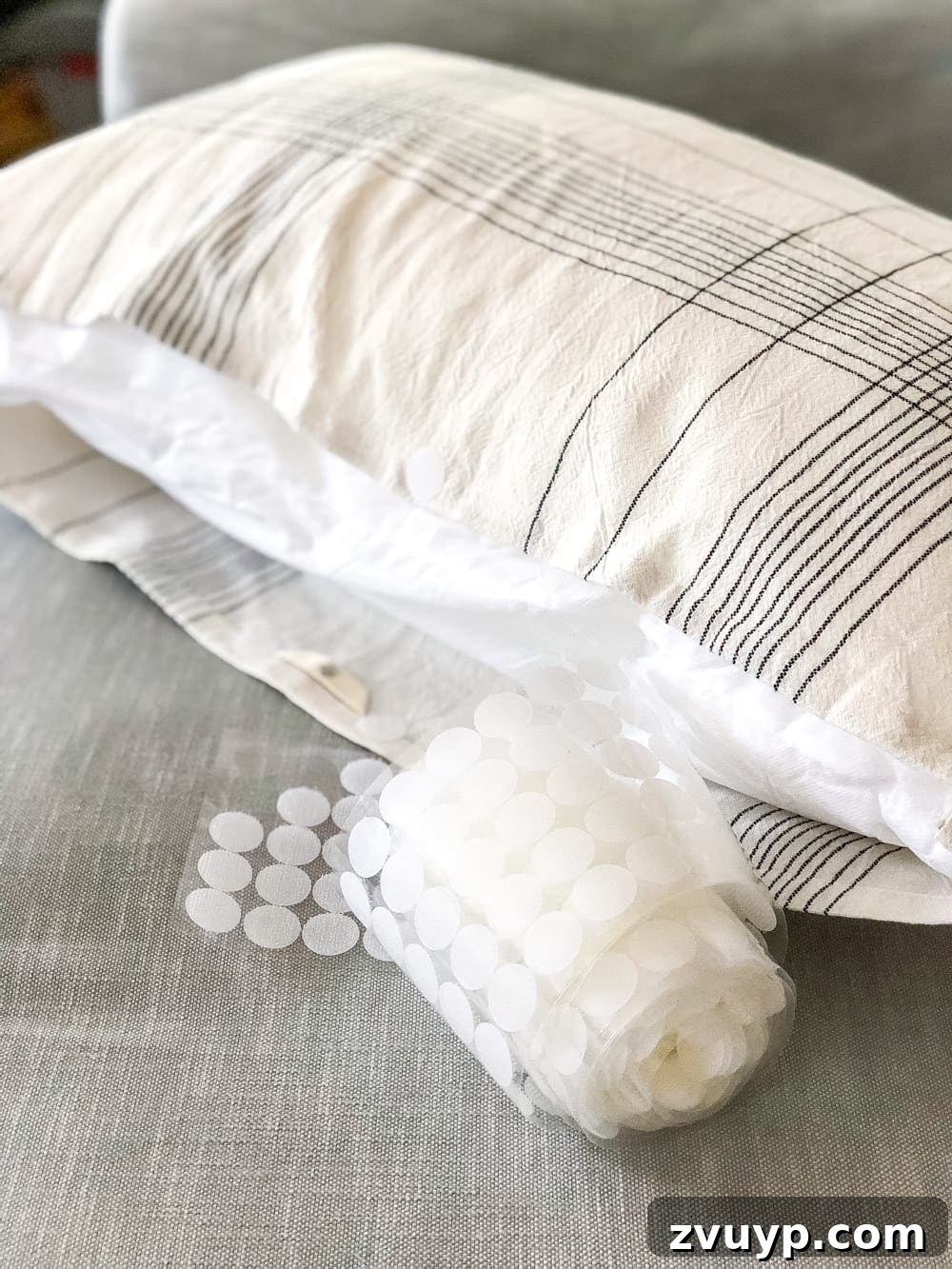 3 Clever Ways to Upcycle Household Items into DIY Throw Pillows 8 How to make a throw pillow from a kitchen towel, showing the final step of closing the opening with Velcro.