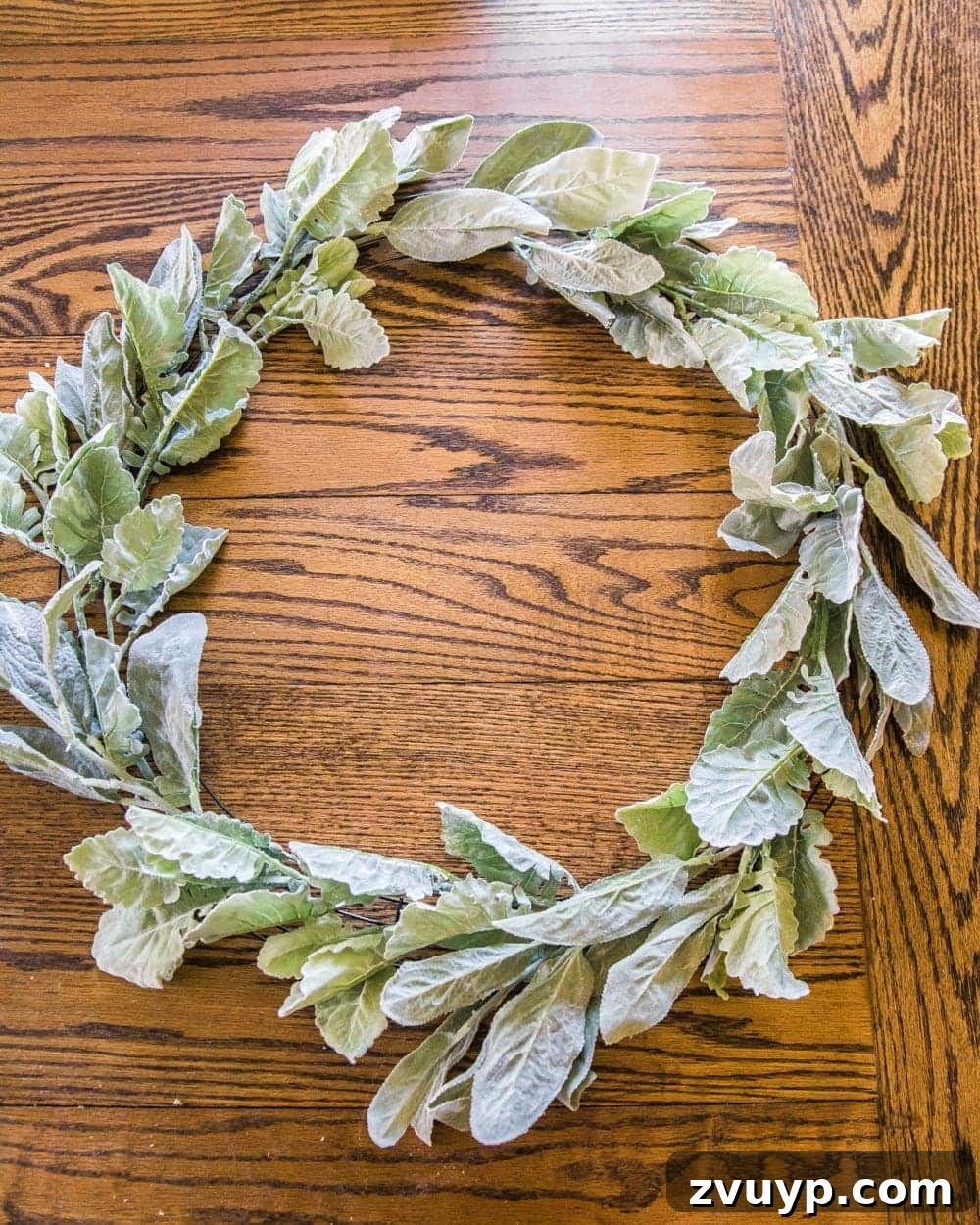 Handcrafted Sage and Blush Spring Wreath 5 DIY Sage and Blush Spring Wreath Tutorial | Step 1: Attaching individual lamb's ear stems to the wire wreath form for a full, soft greenery base.