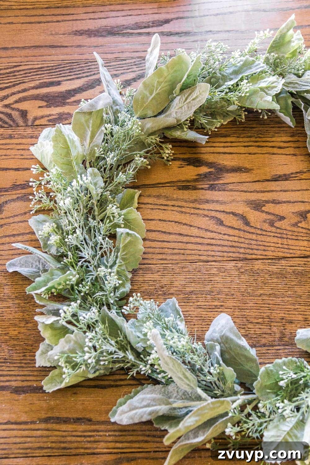 Handcrafted Sage and Blush Spring Wreath 6 DIY Sage and Blush Spring Wreath Tutorial | Step 2: Incorporating artificial white berry stems to add texture and subtle brightness to the greenery base.