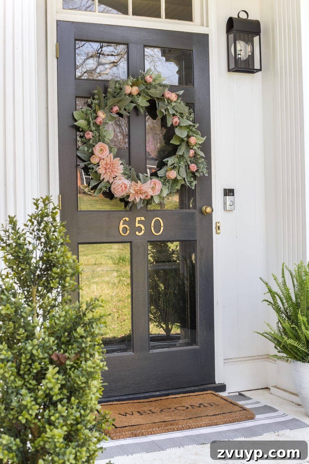 Simple Spring Porch Makeover Ideas 10 A beautiful handmade floral wreath with sage and blush tones on a white front door, perfect for spring.