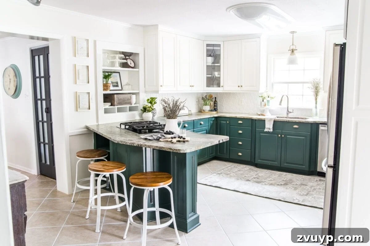 Our Home's Two Year Evolution A Before and After Tour 13 After shot of our refreshed kitchen, highlighting a light and airy design with painted cabinets, new hardware, and updated lighting.