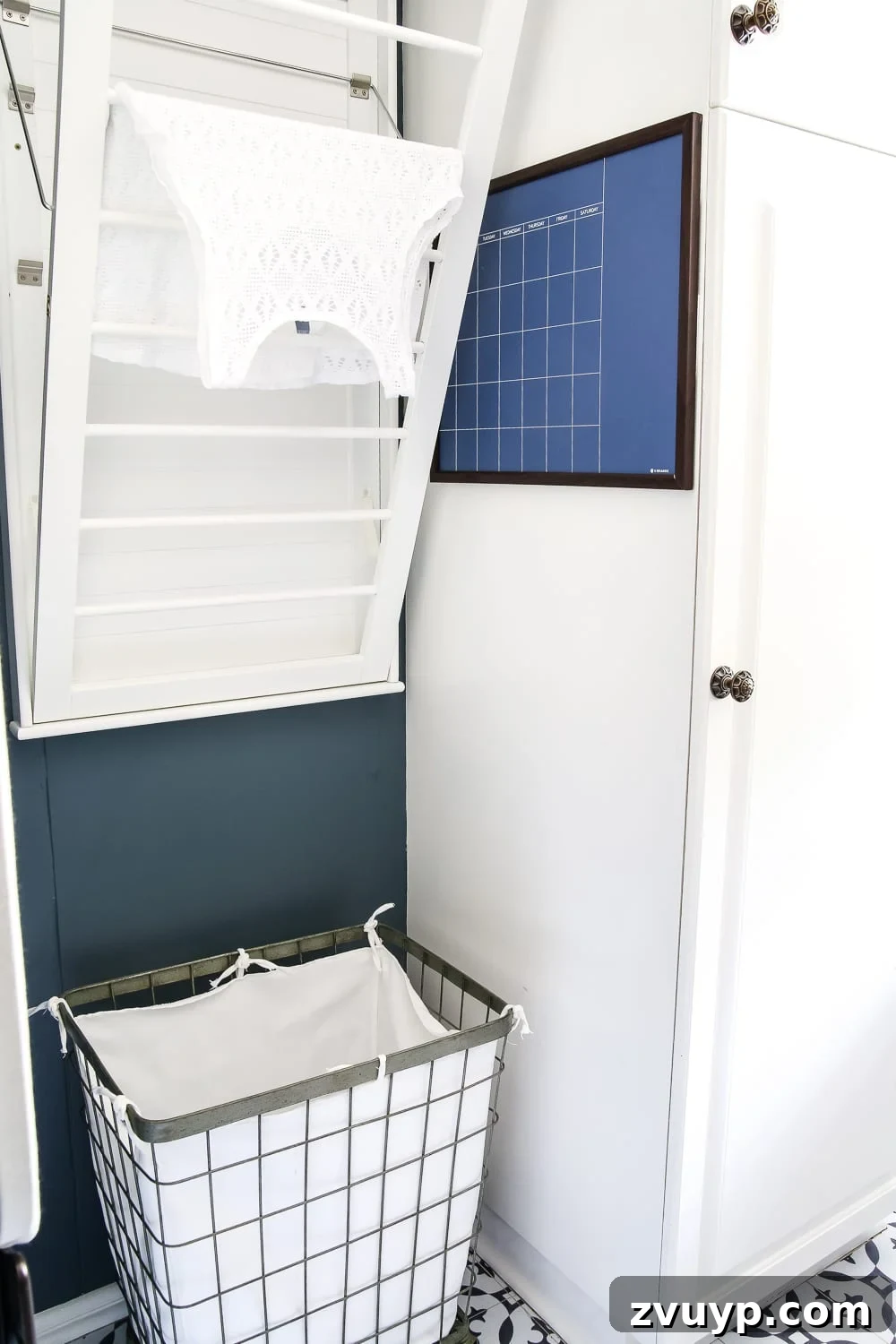 Our Home's Two Year Evolution A Before and After Tour 23 Detailed view of the laundry room's organized shelves with stylish baskets and practical items, against the dark Slate Tile walls.