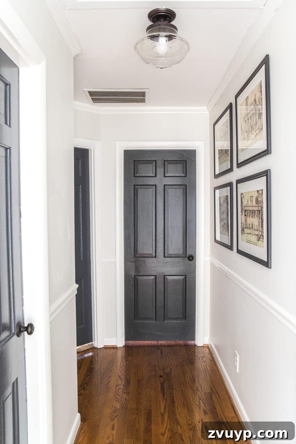 Our Home's Two Year Evolution A Before and After Tour 41 Close-up of framed architectural printable art adorning the hallway walls, adding character and visual interest to the space.