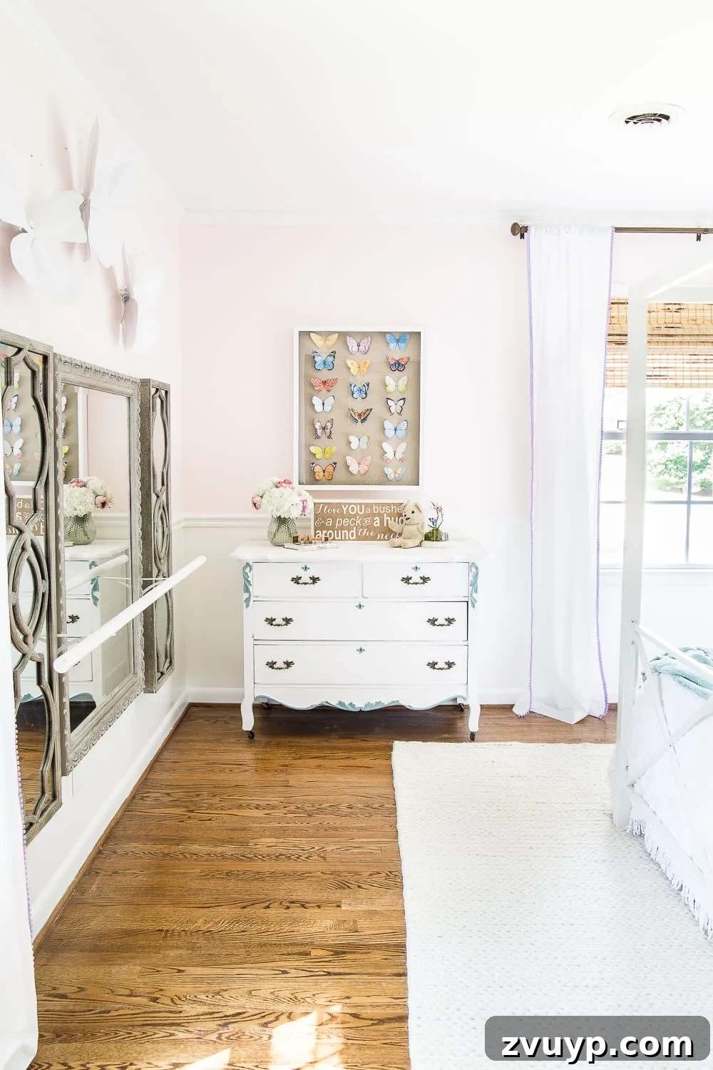 Our Home's Two Year Evolution A Before and After Tour 44 Close-up of Olivia's bed area, adorned with butterfly garlands and soft bedding, creating a magical and comfortable sleeping space.