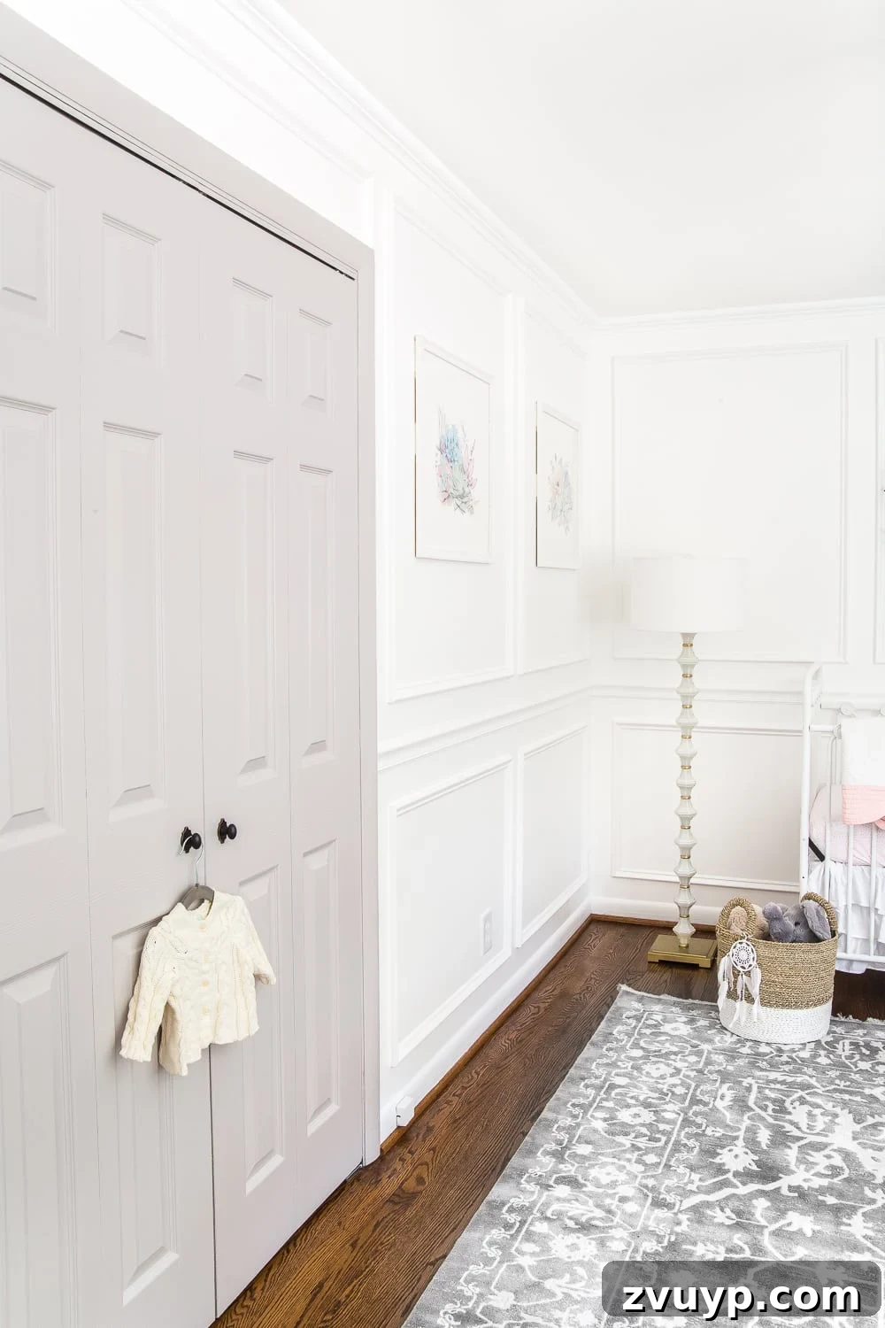 Our Home's Two Year Evolution A Before and After Tour 50 Close-up of nursery decor, including stuffed animals and framed prints, against the soft white walls.