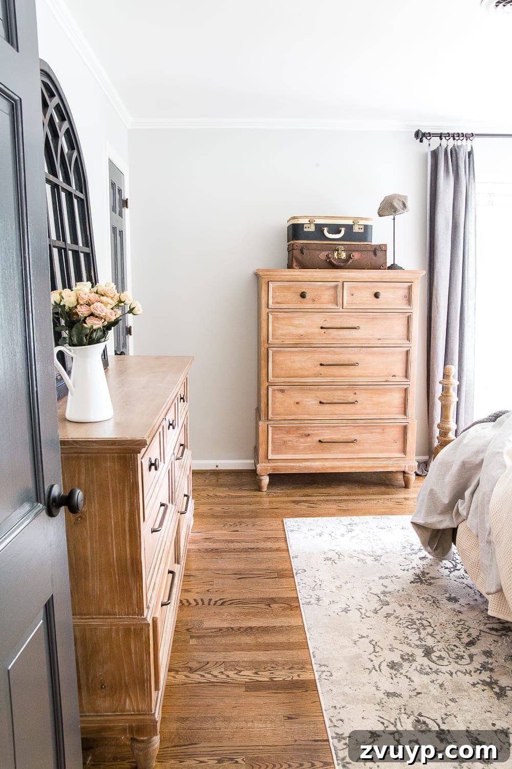 Our Home's Two Year Evolution A Before and After Tour 57 Another view of the master bedroom, highlighting a stylish bench at the foot of the bed and framed art, enhancing the room's serene elegance.