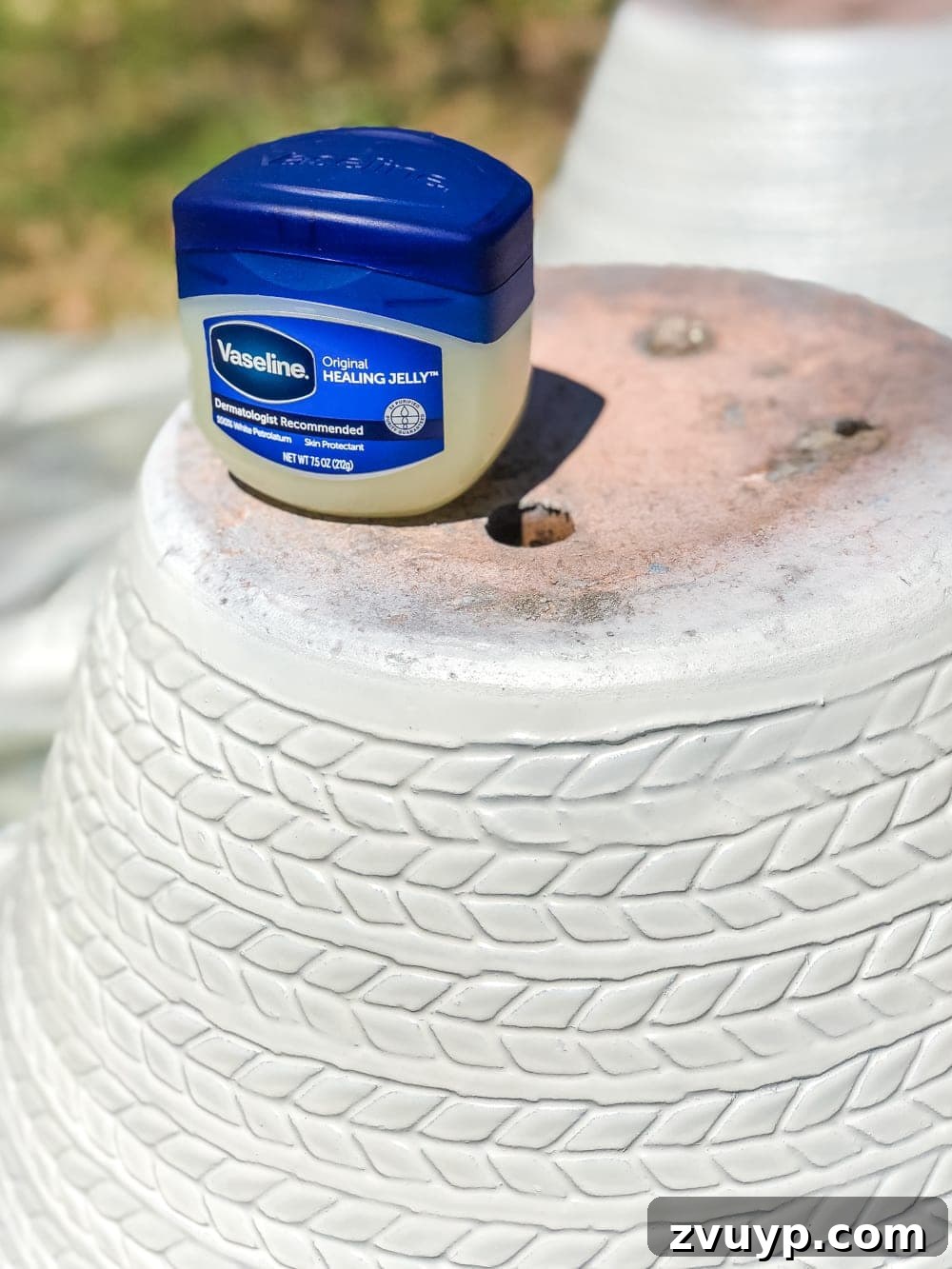 Apply Vaseline generously to areas where you want the base paint to show through for a weathered effect.