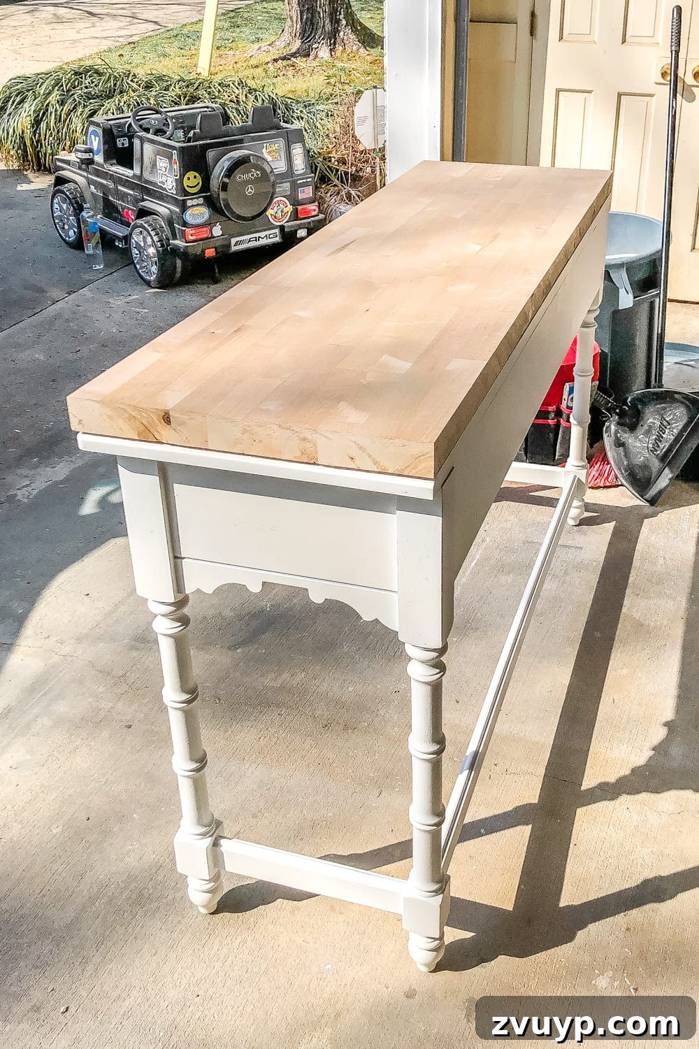 Upgrade Your Console Table to a Stunning Bathroom Vanity 11 A butcher block countertop being prepared for sink cutouts, showing a car in the background.